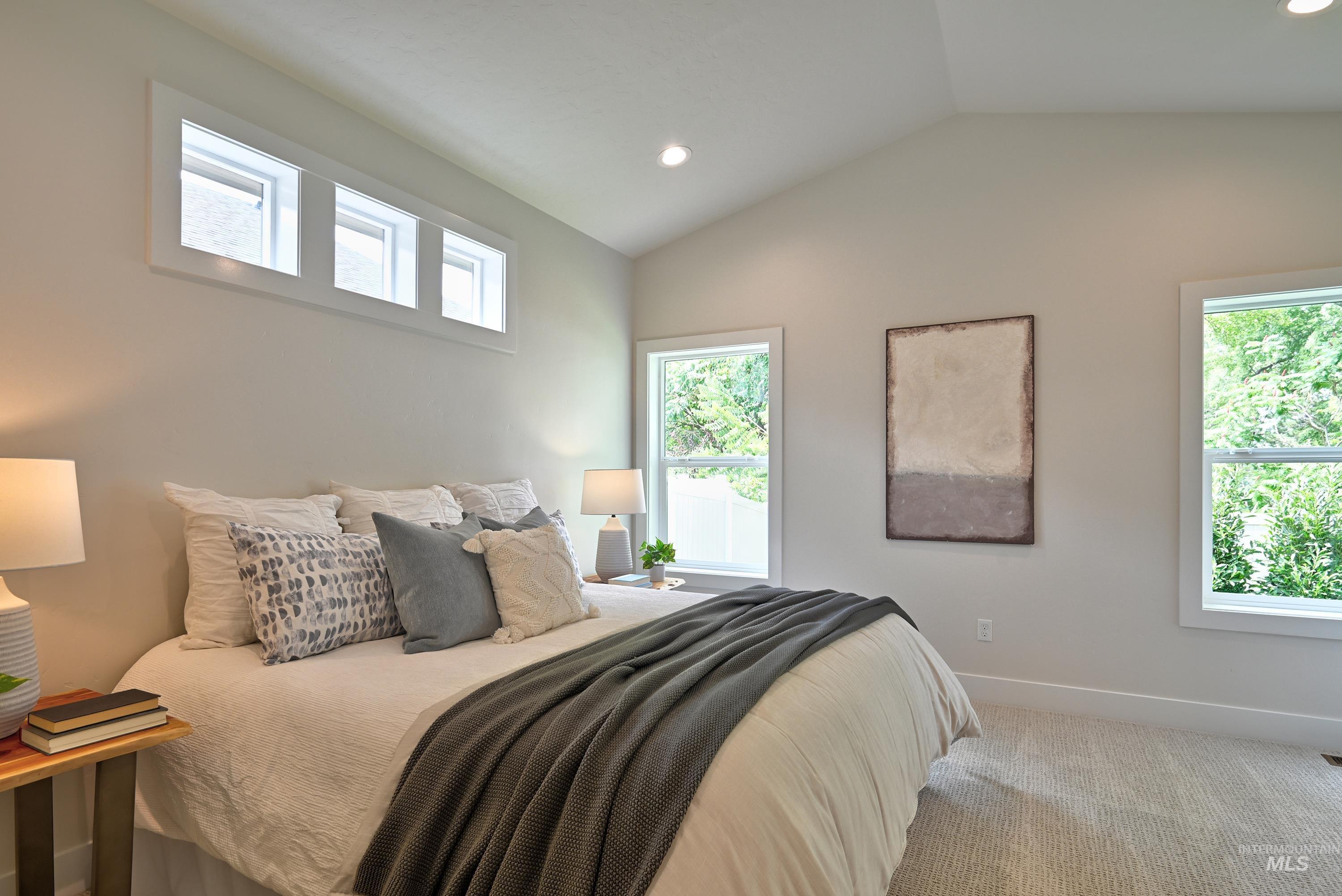 Primary Bedroom featuring lofted ceiling, recessed lighting, fan and carpet flooring