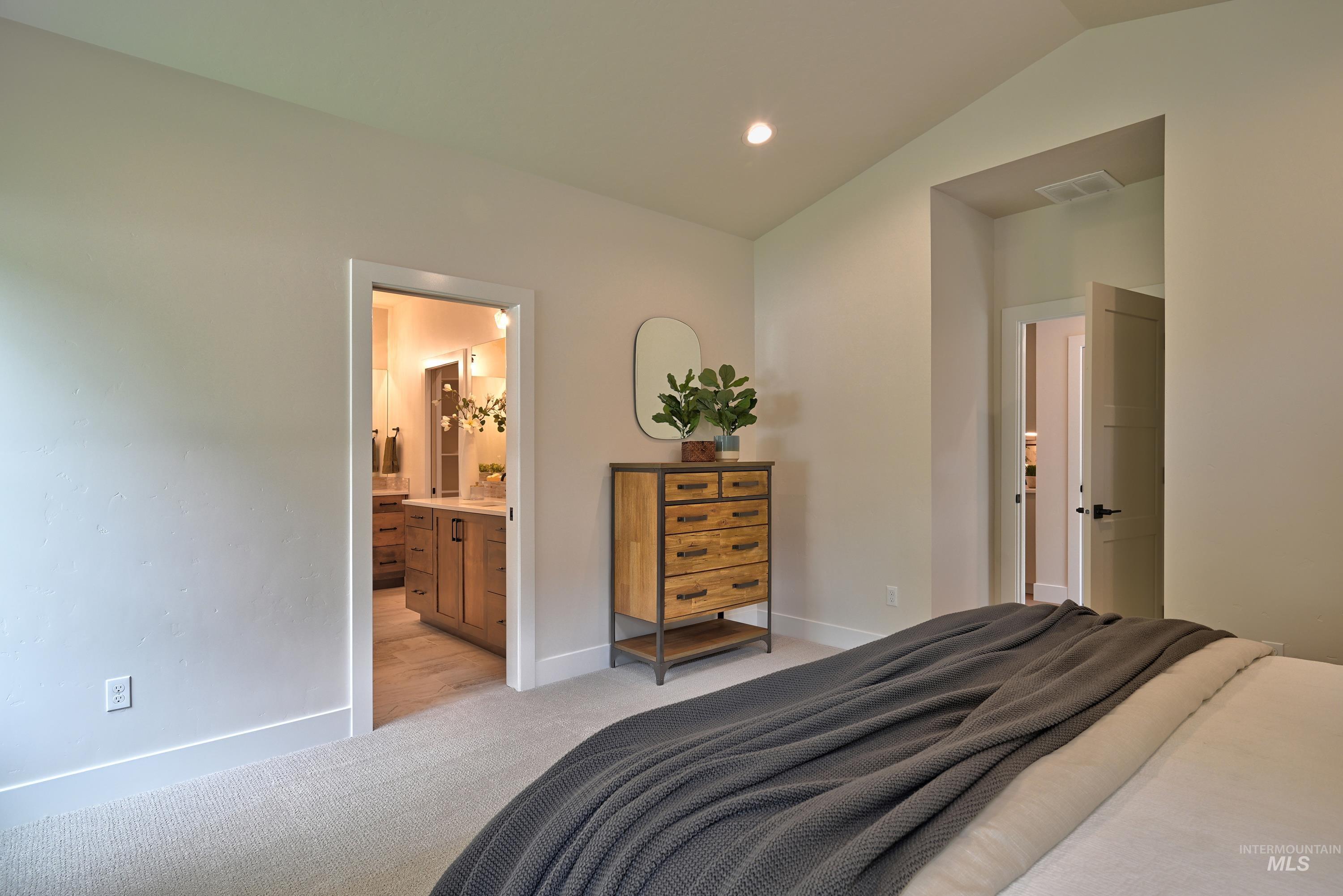Bedroom with light carpet, Ensuite bathroom, and recessed lighting