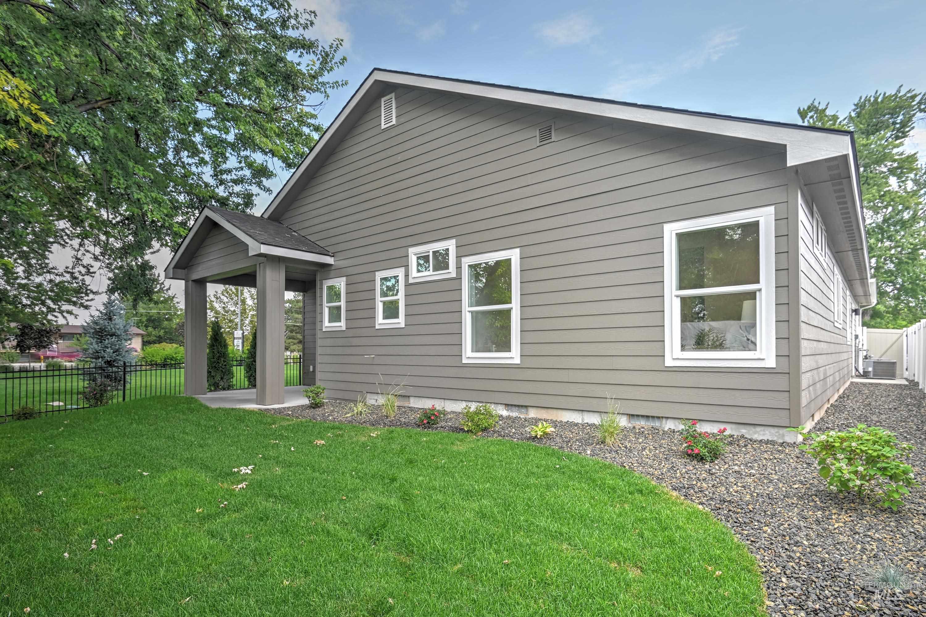 Rear view of property featuring a covered patio