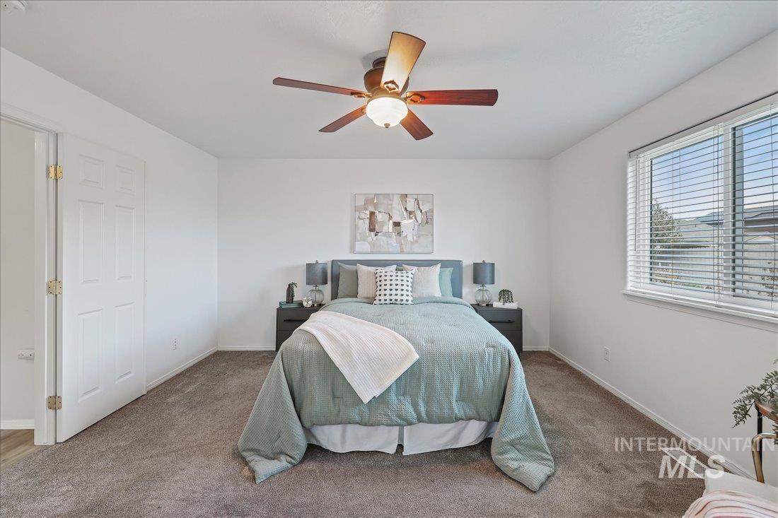 Bedroom with carpet and a ceiling fan