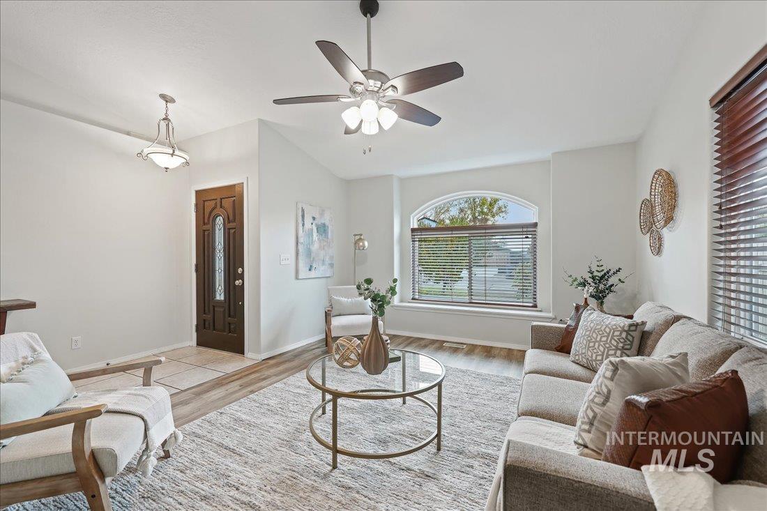 Living area featuring wood finished floors and ceiling fan