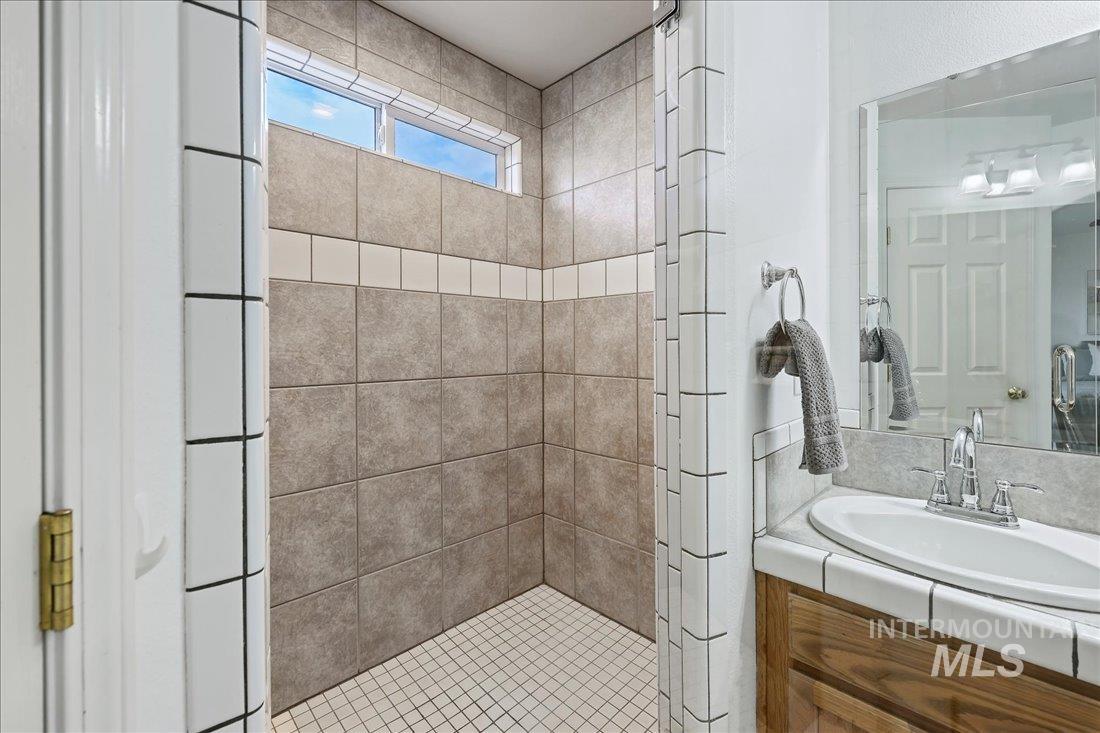 Bathroom featuring vanity and a stall shower