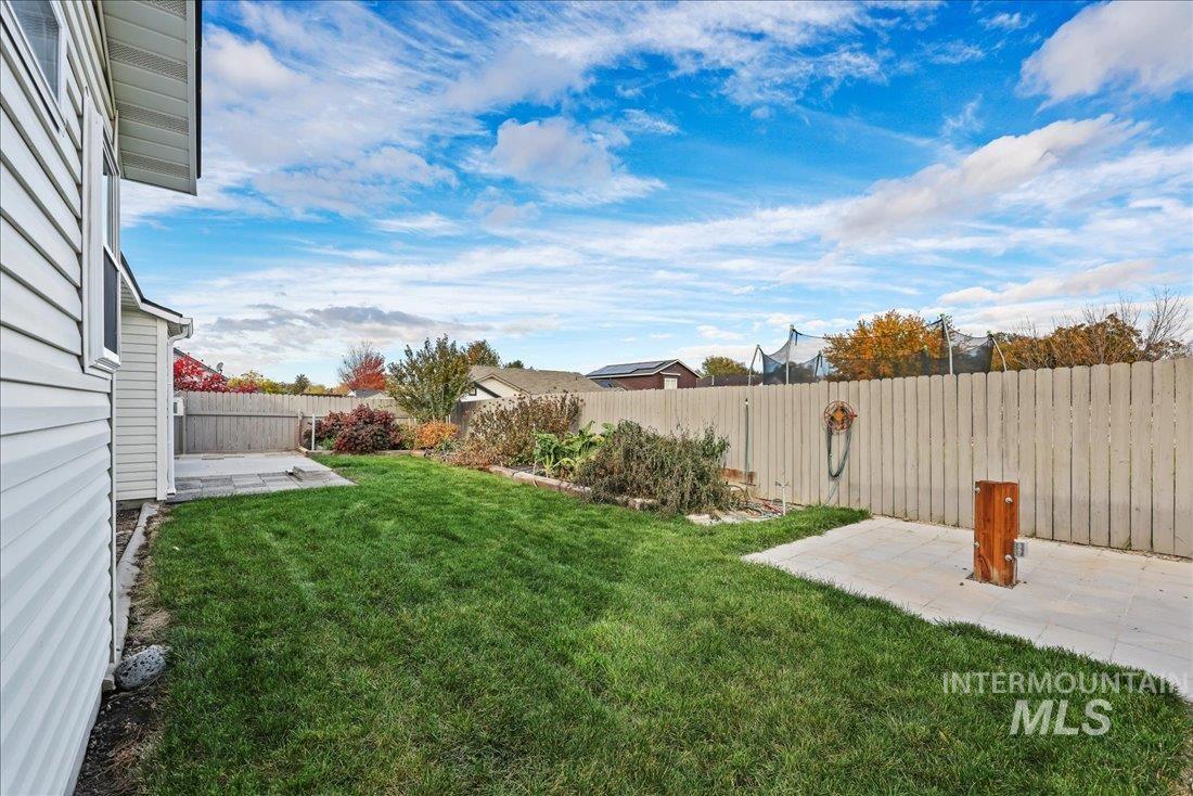 Fenced backyard featuring a patio