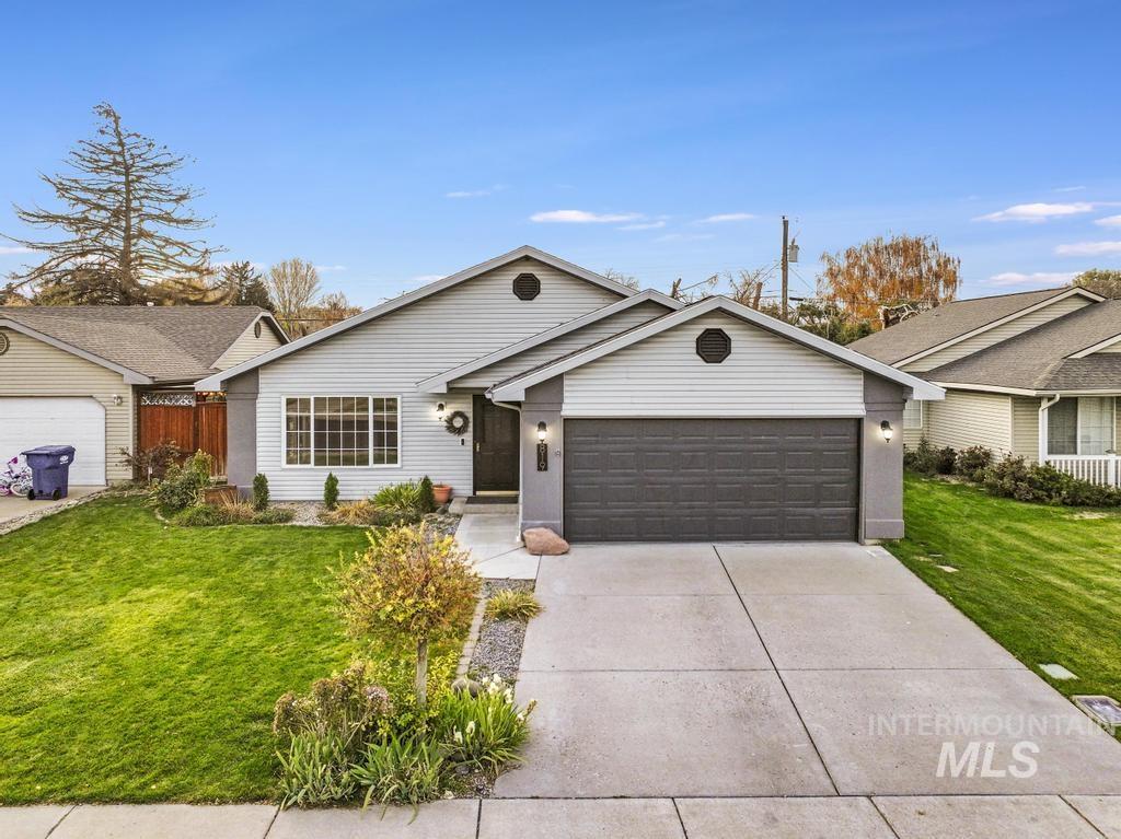 Ranch-style house featuring an attached garage and concrete driveway