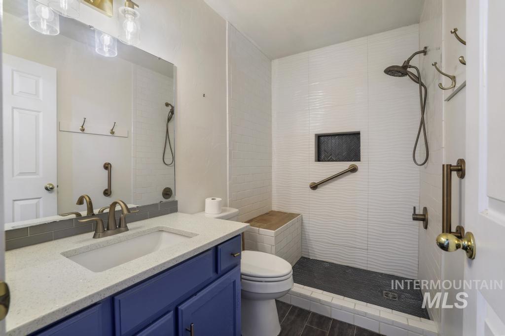 Bathroom with vanity and tiled shower