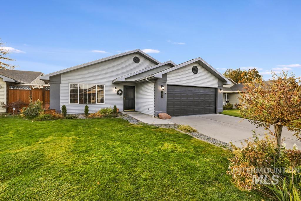 Ranch-style home featuring driveway and a garage