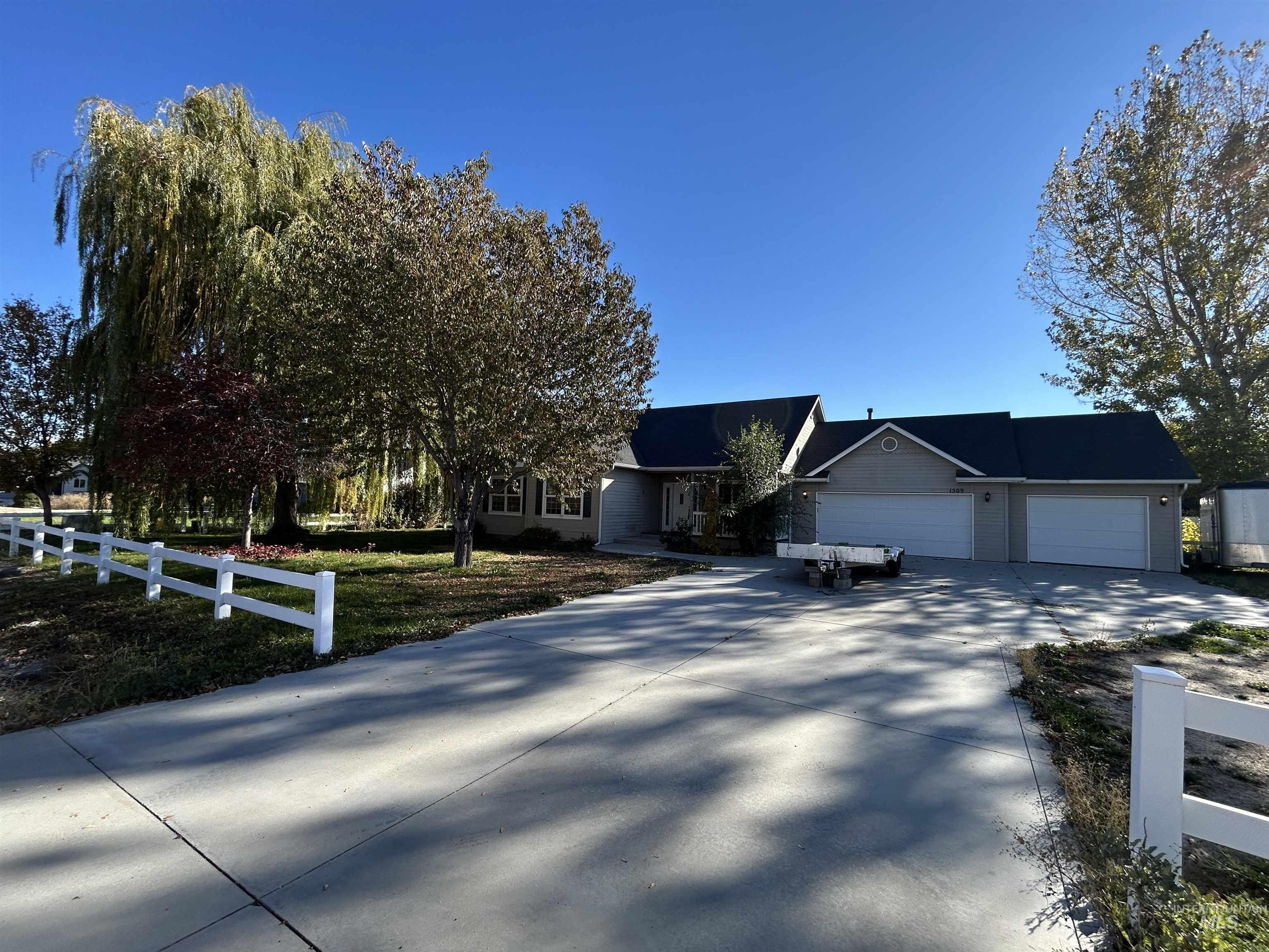 View of front of house featuring concrete driveway and a garage