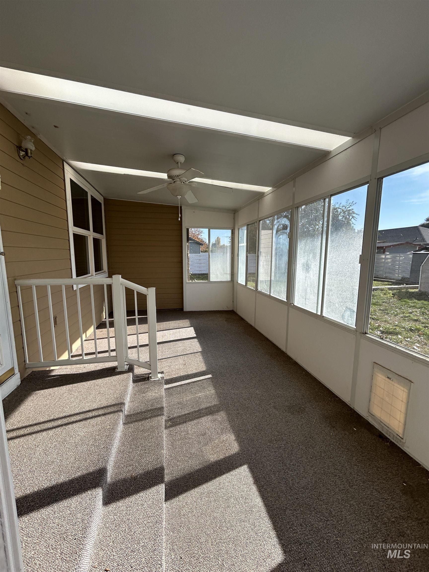 Unfurnished sunroom featuring carpet floors
