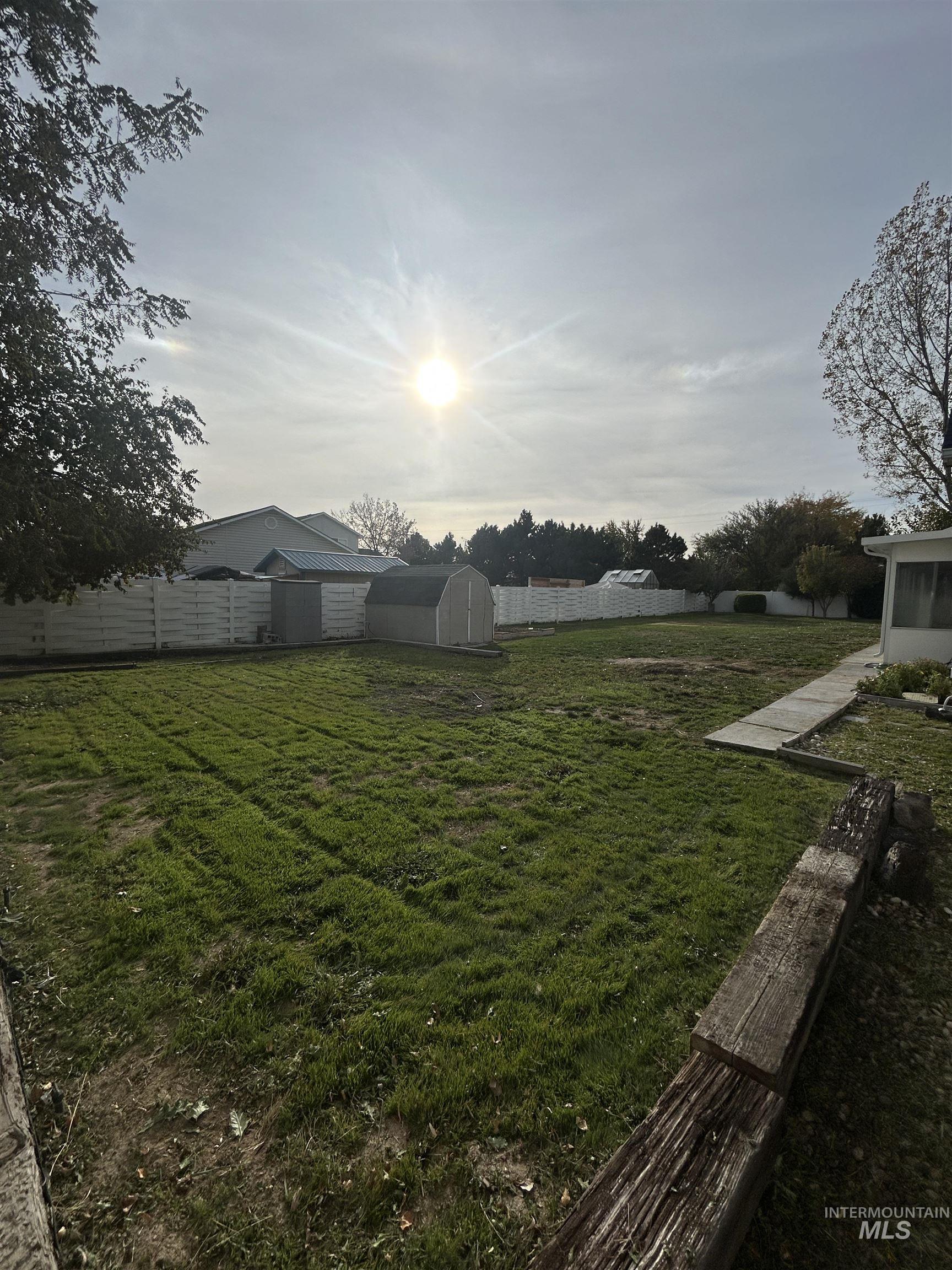 Fenced backyard with a shed