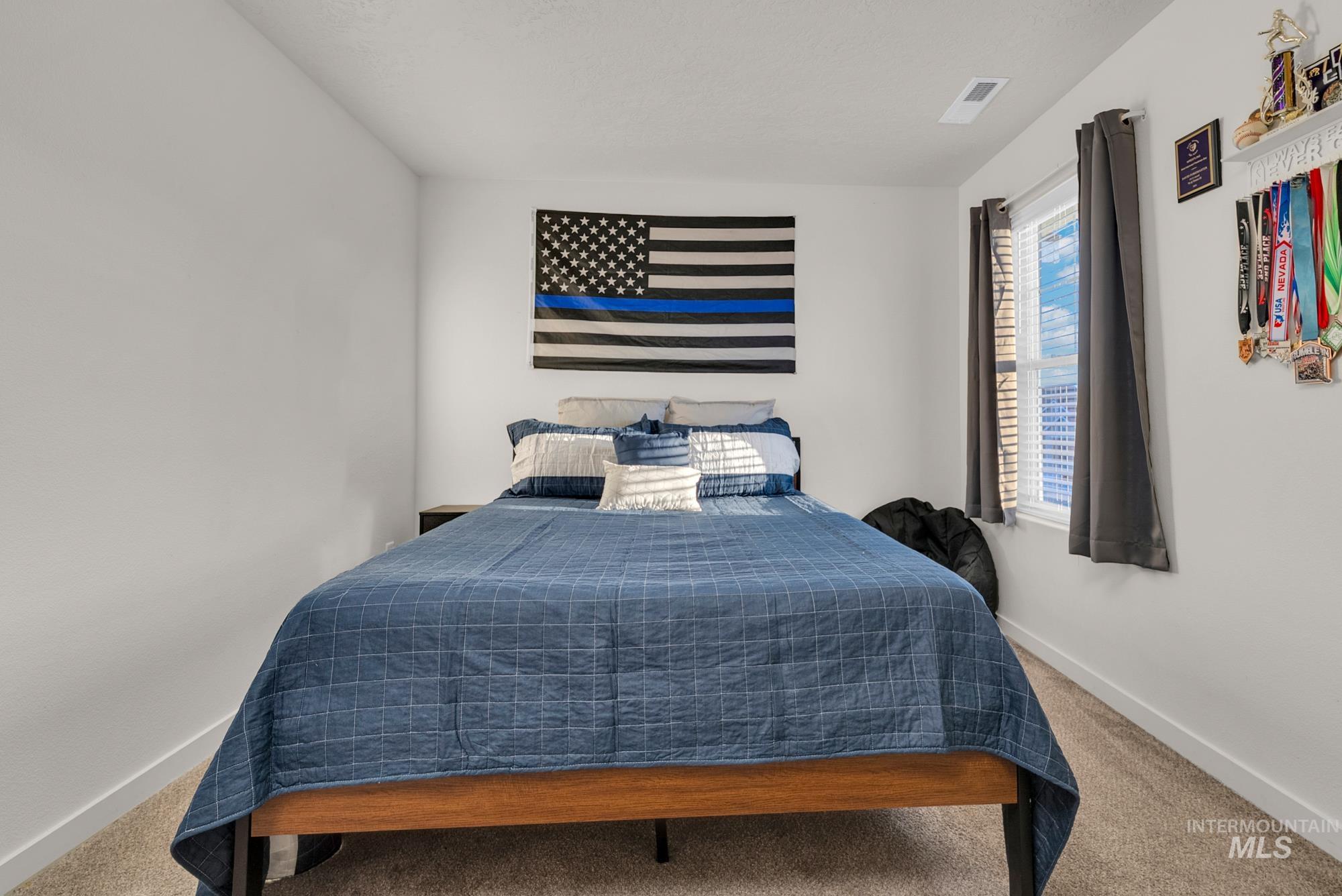 Bedroom featuring carpet flooring and baseboards