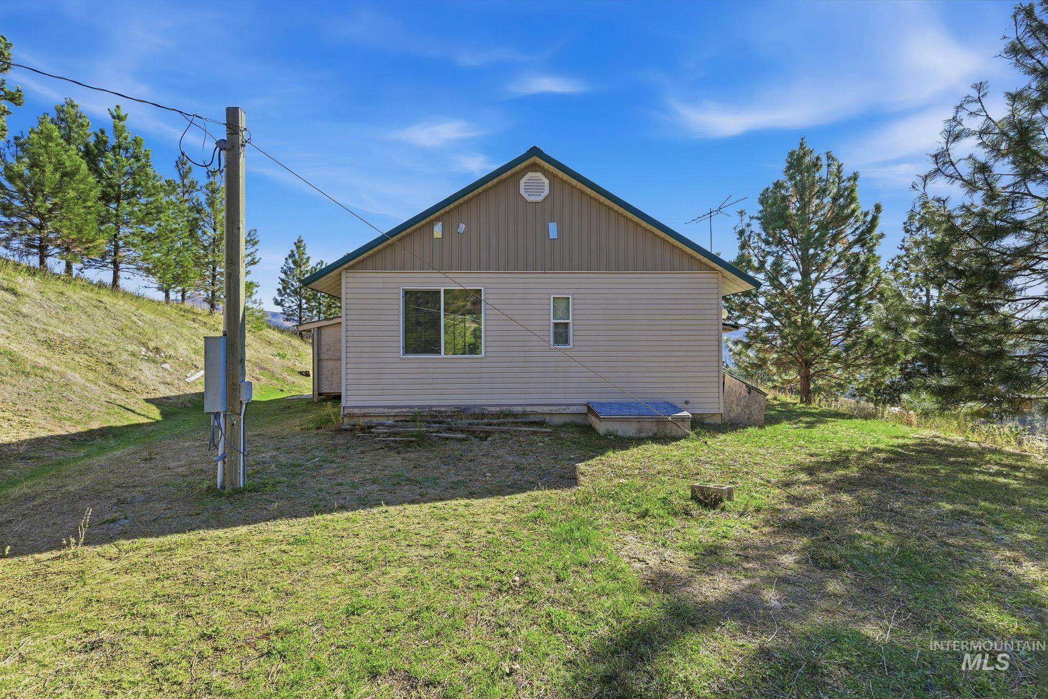 View of side of home with a lawn