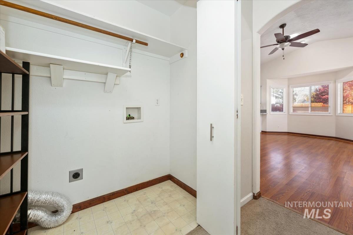 Washroom featuring vaulted ceiling, electric dryer hookup, a ceiling fan, washer hookup, and light flooring