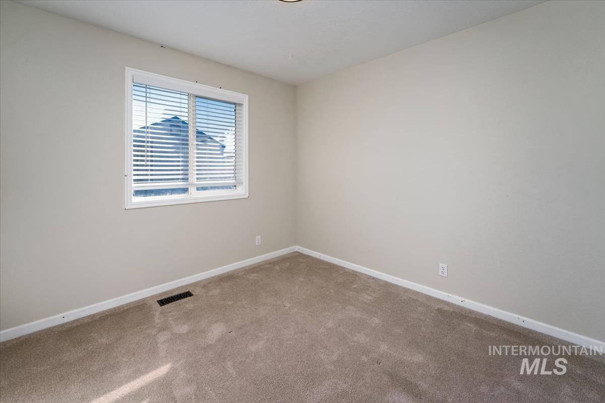 Unfurnished room with baseboards and carpet