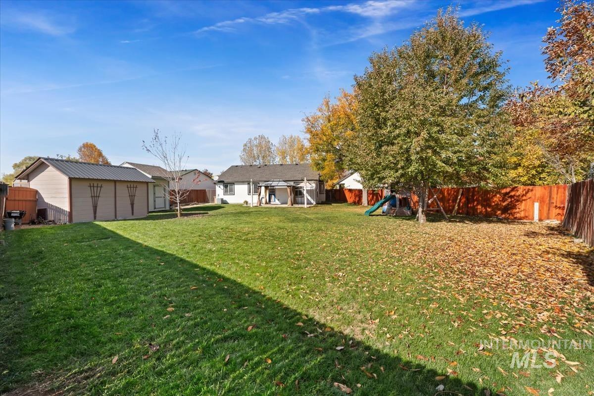 Fenced backyard with a playground