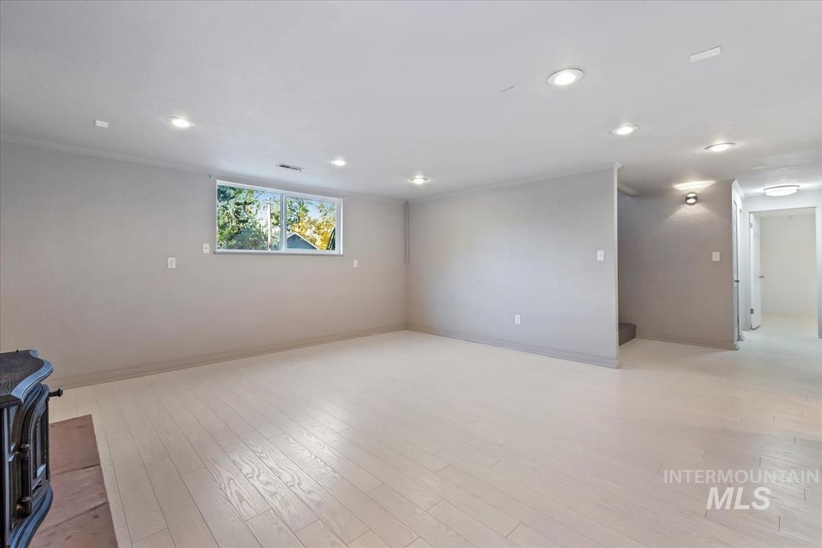 Spare room with light wood finished floors and recessed lighting