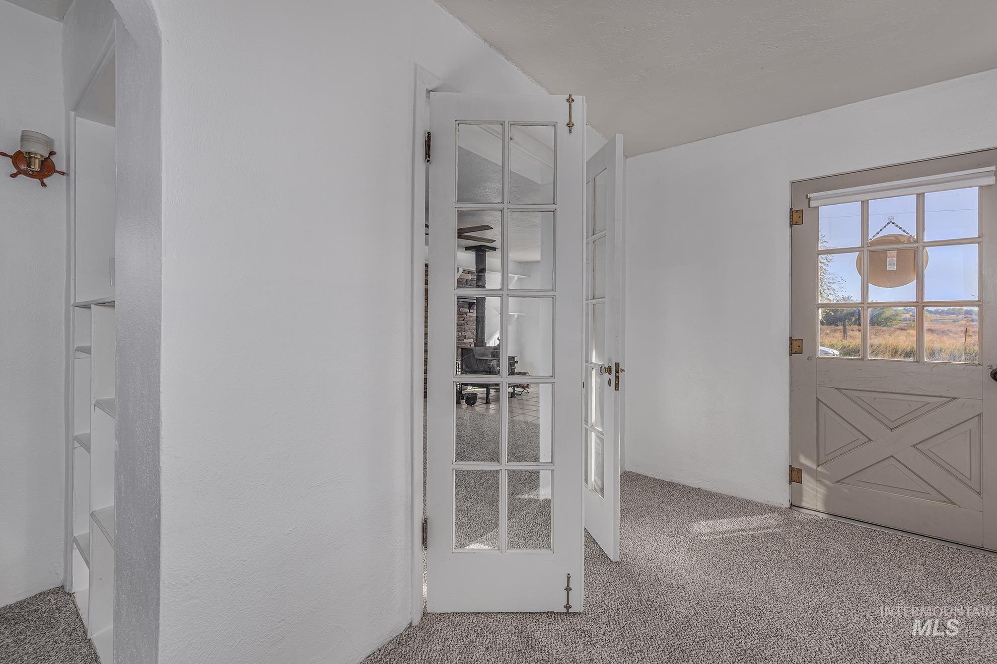 Doorway to outside featuring carpet