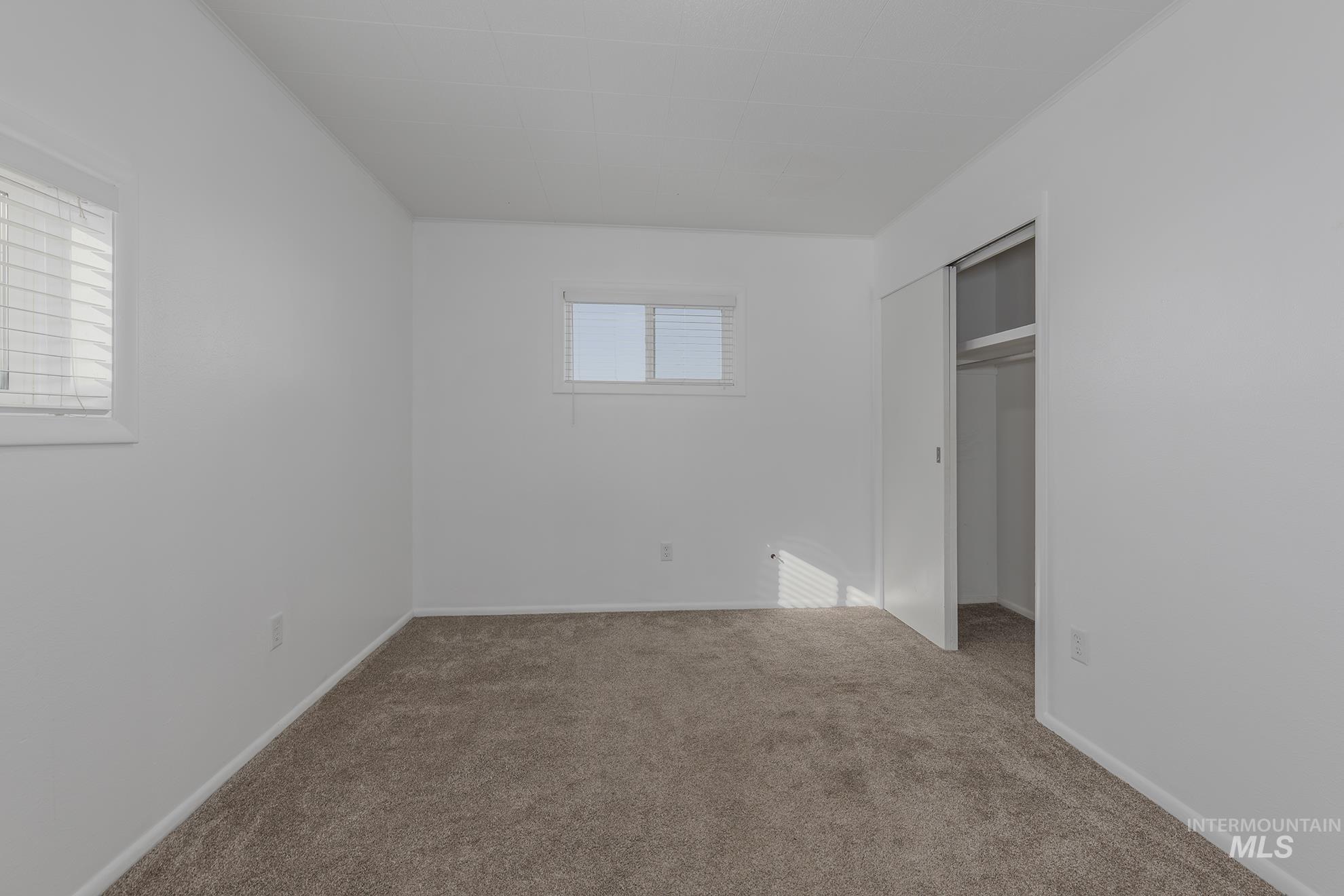 Unfurnished bedroom featuring a closet and carpet floors