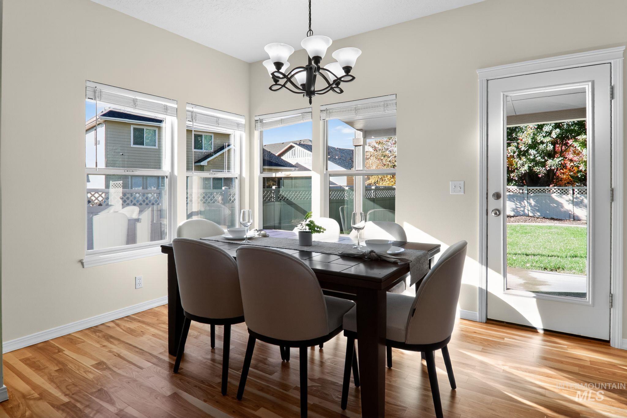 Dining room with light wood-style flooring and a chandelier