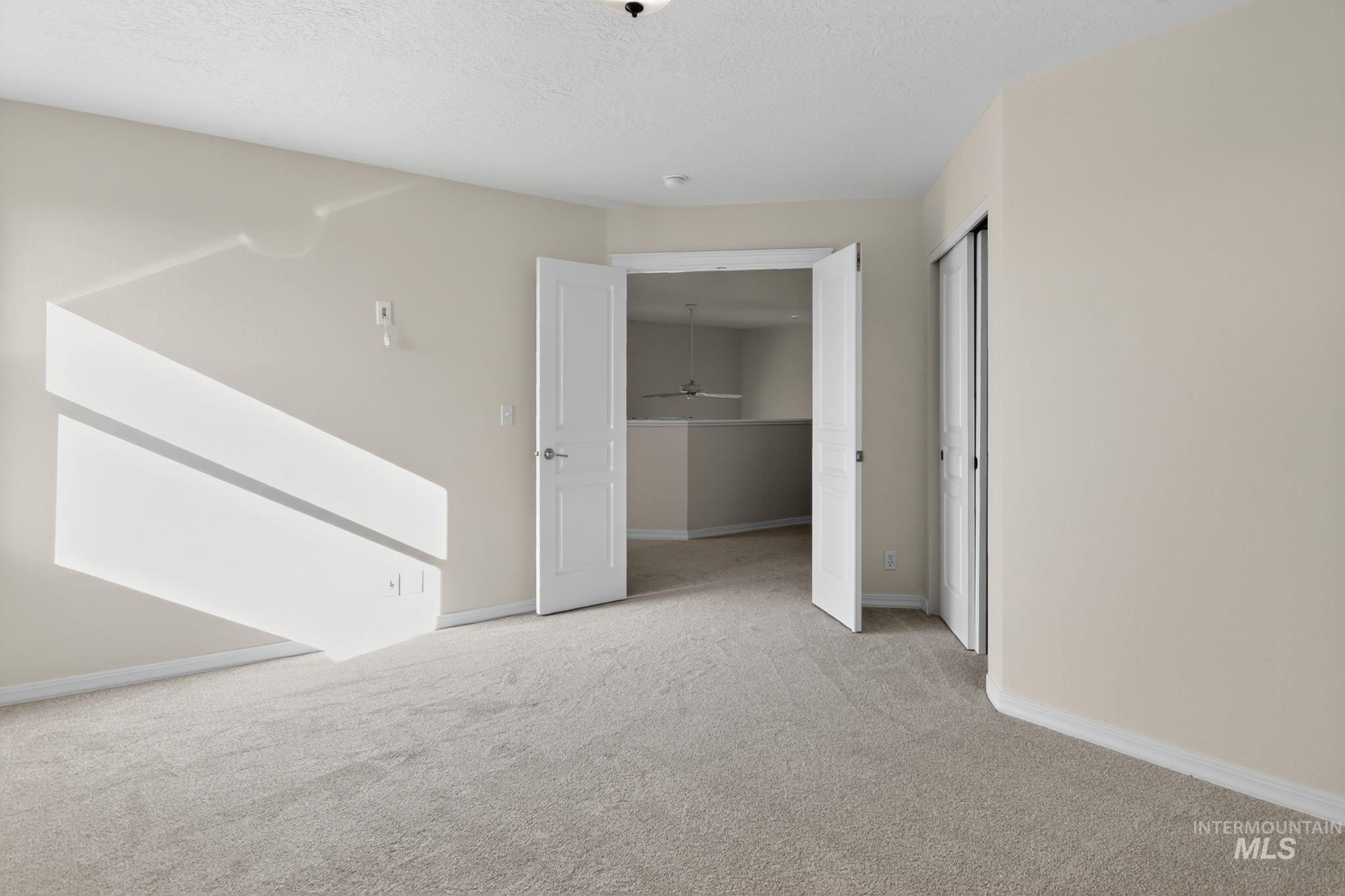 Unfurnished bedroom with carpet flooring and a textured ceiling
