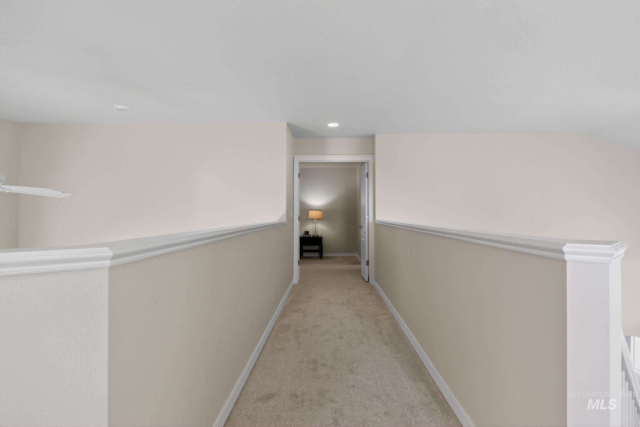 Hall featuring light carpet, an upstairs landing, and recessed lighting