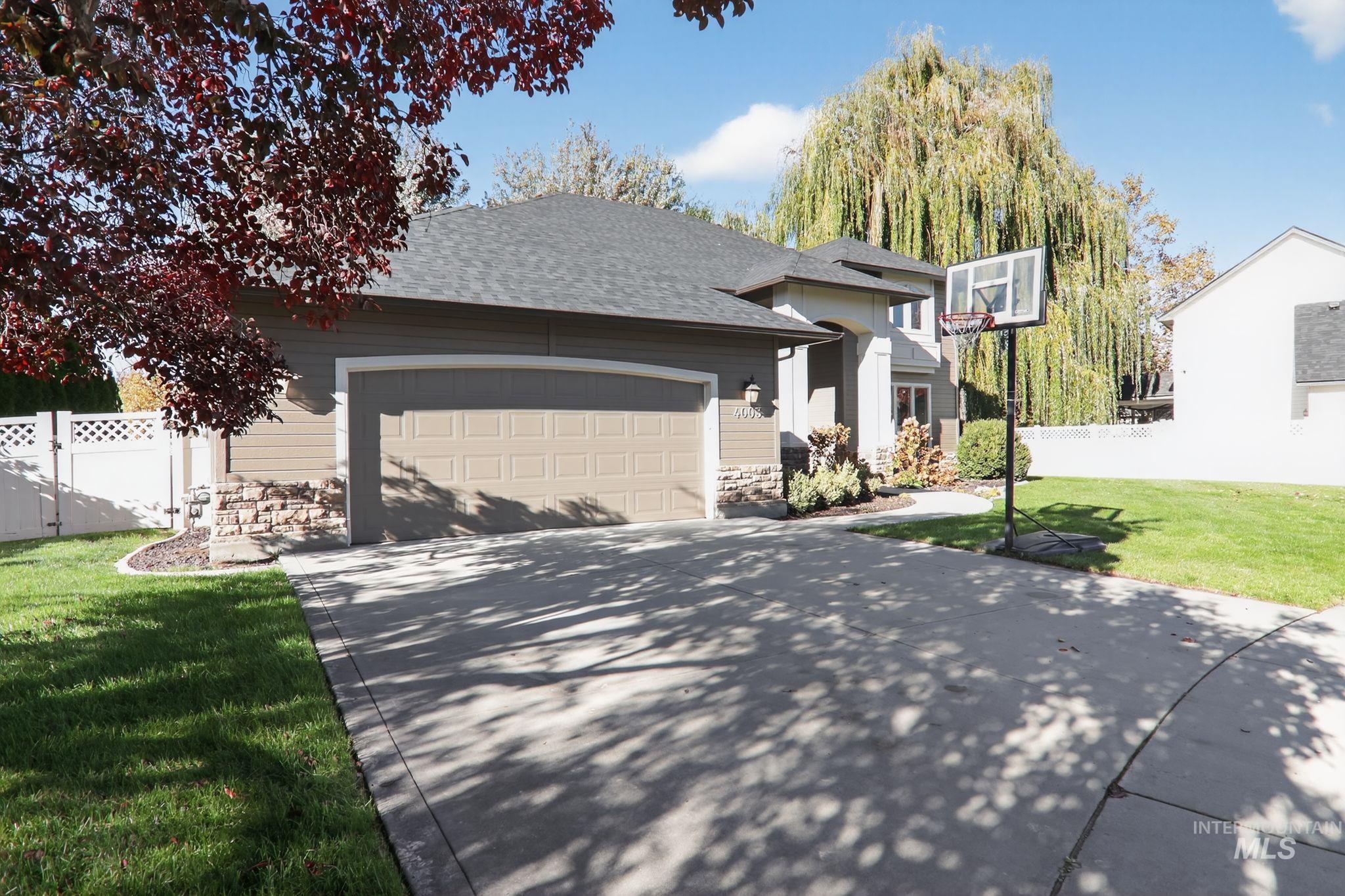 View of front of house featuring roof with shingles, a garage, and concrete driveway
