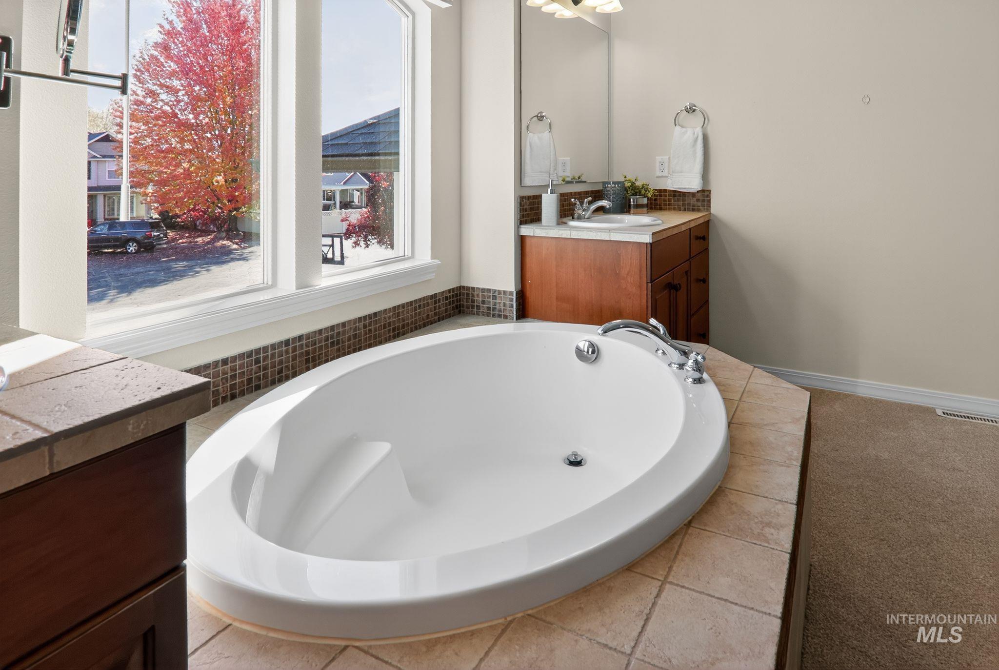 Bathroom featuring vanity and a garden tub