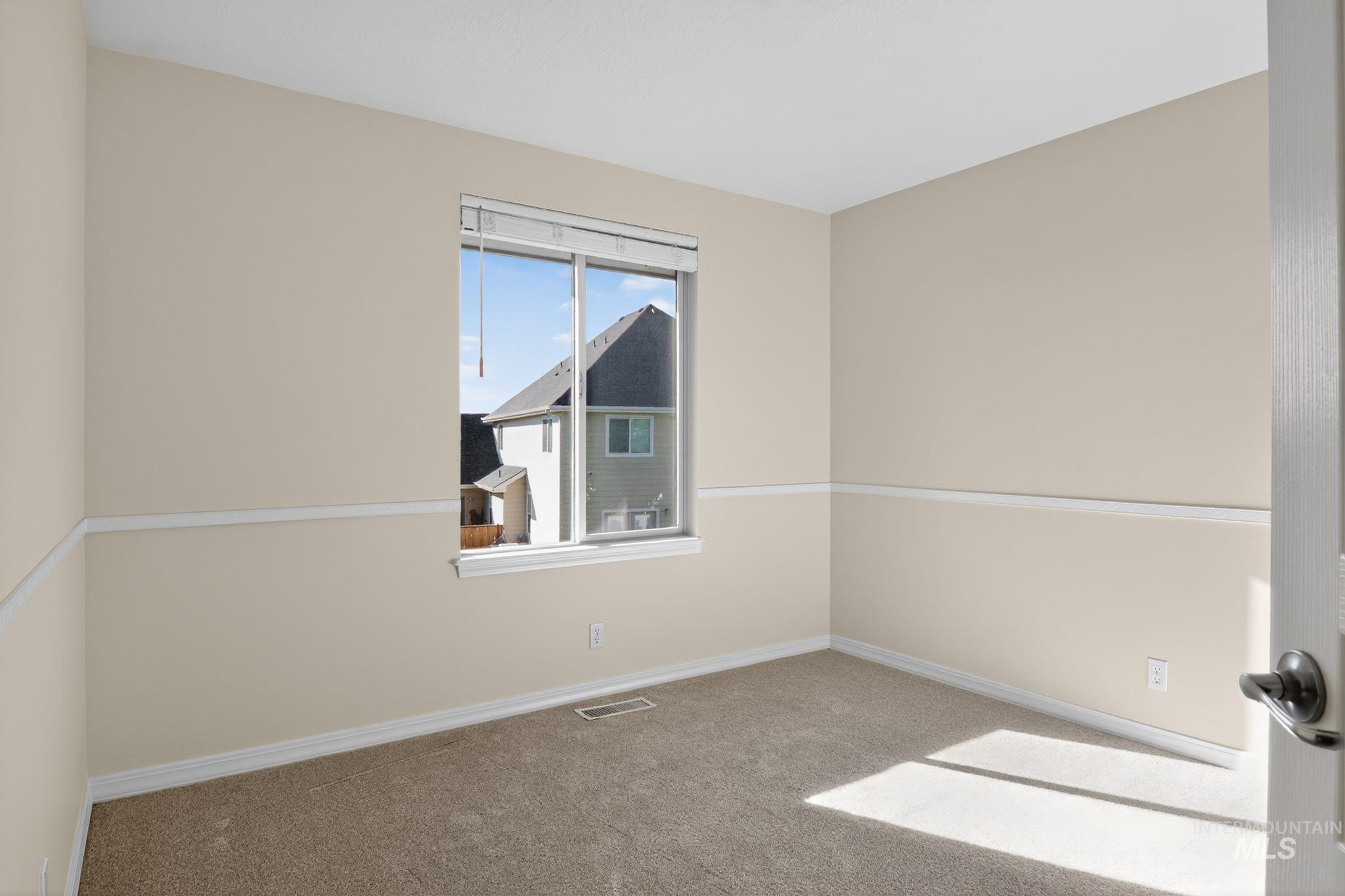 Unfurnished room with carpet floors and baseboards