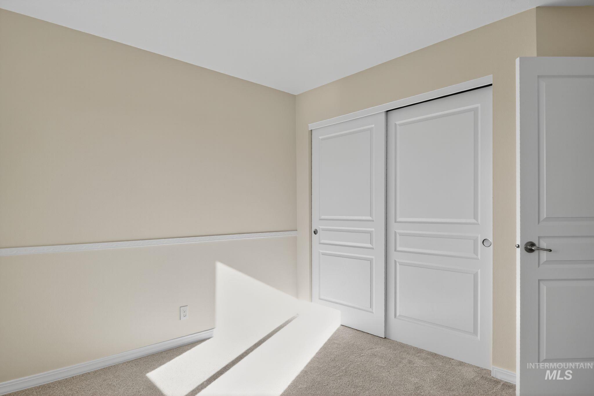 Unfurnished bedroom with carpet floors and a closet