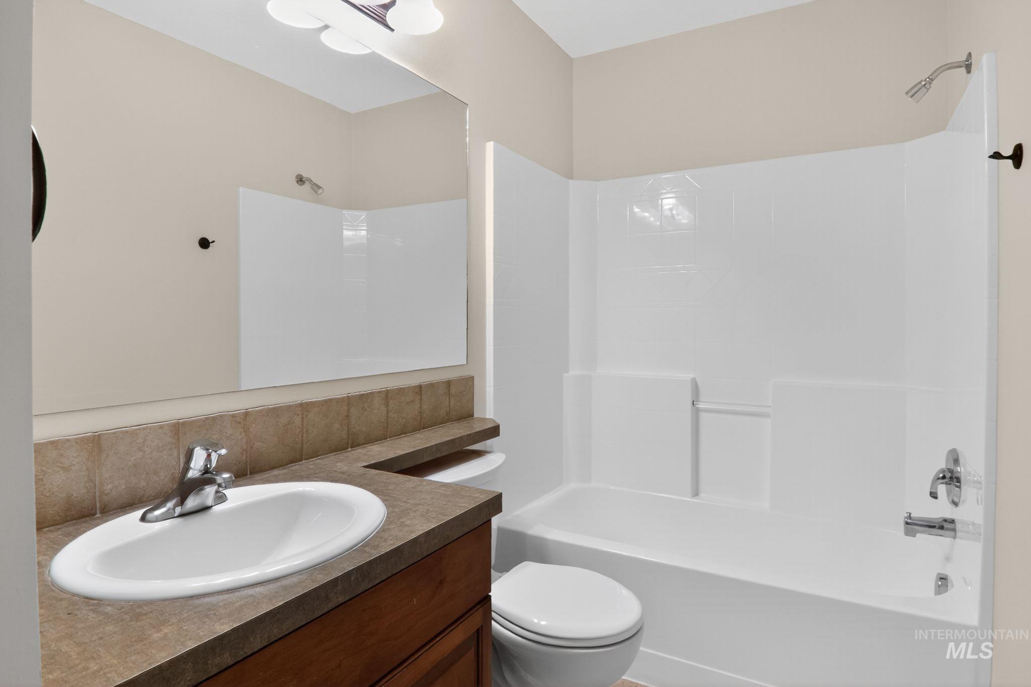 Full bath featuring vanity and shower / tub combination