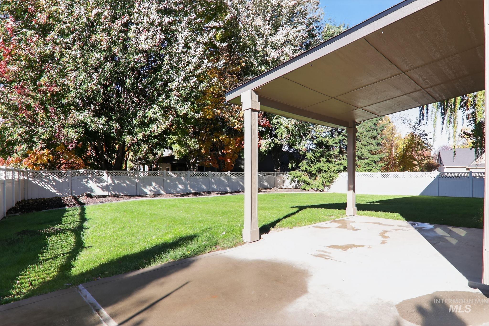 Fenced backyard with a patio