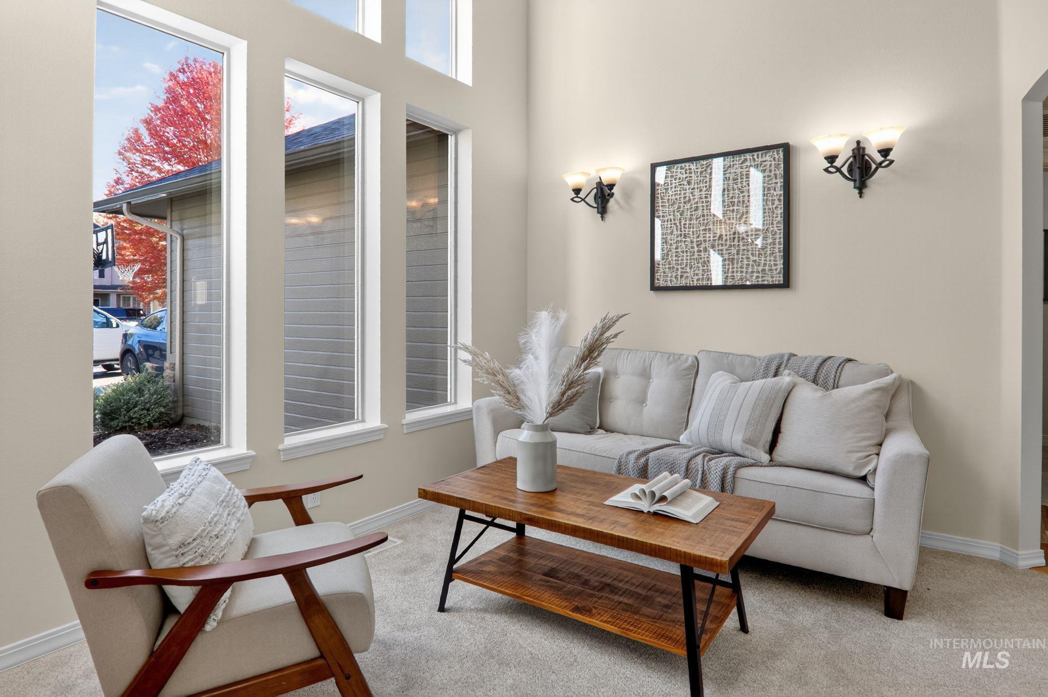 Carpeted living area featuring baseboards