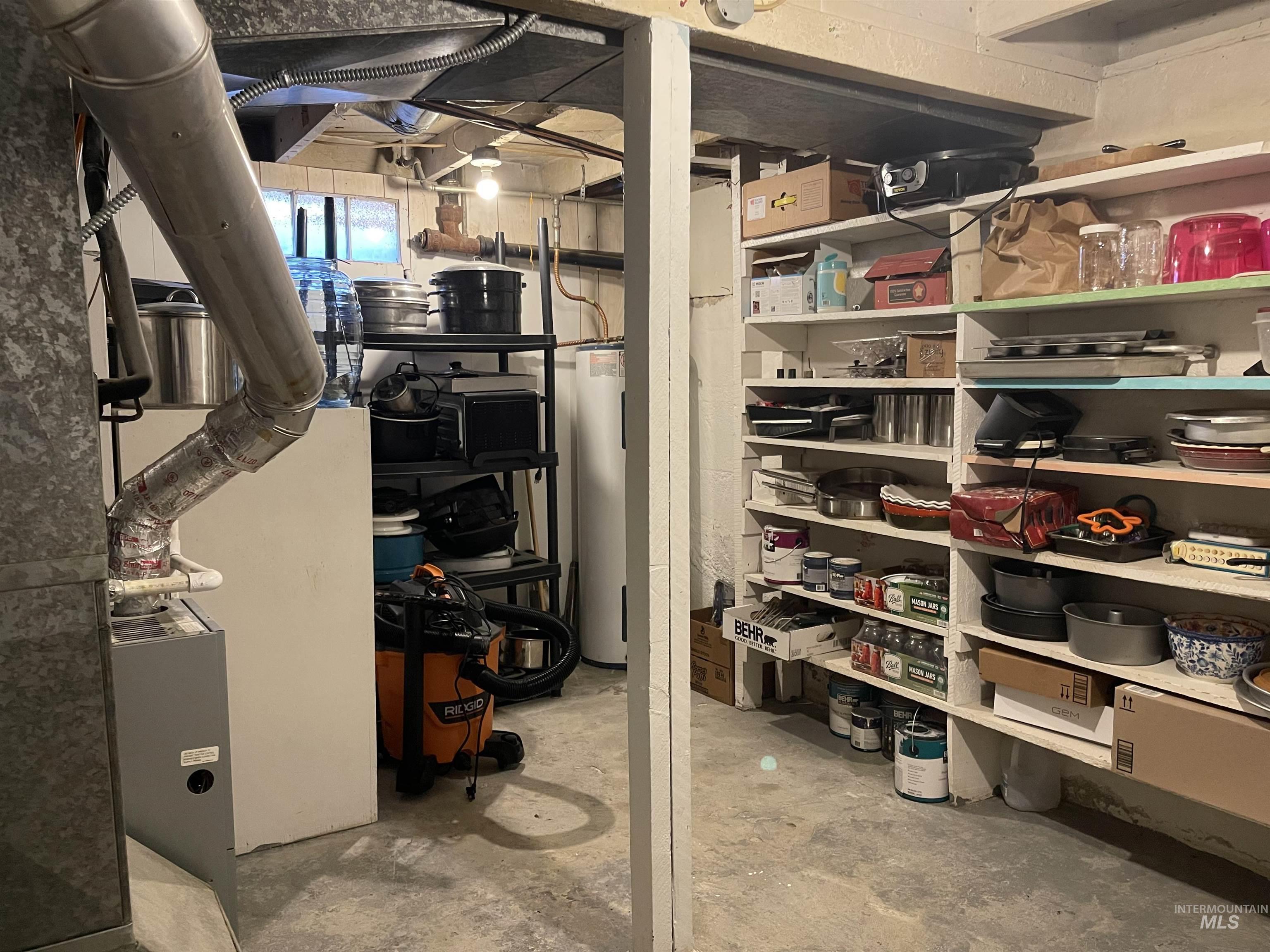 Storage area featuring water heater and heating unit