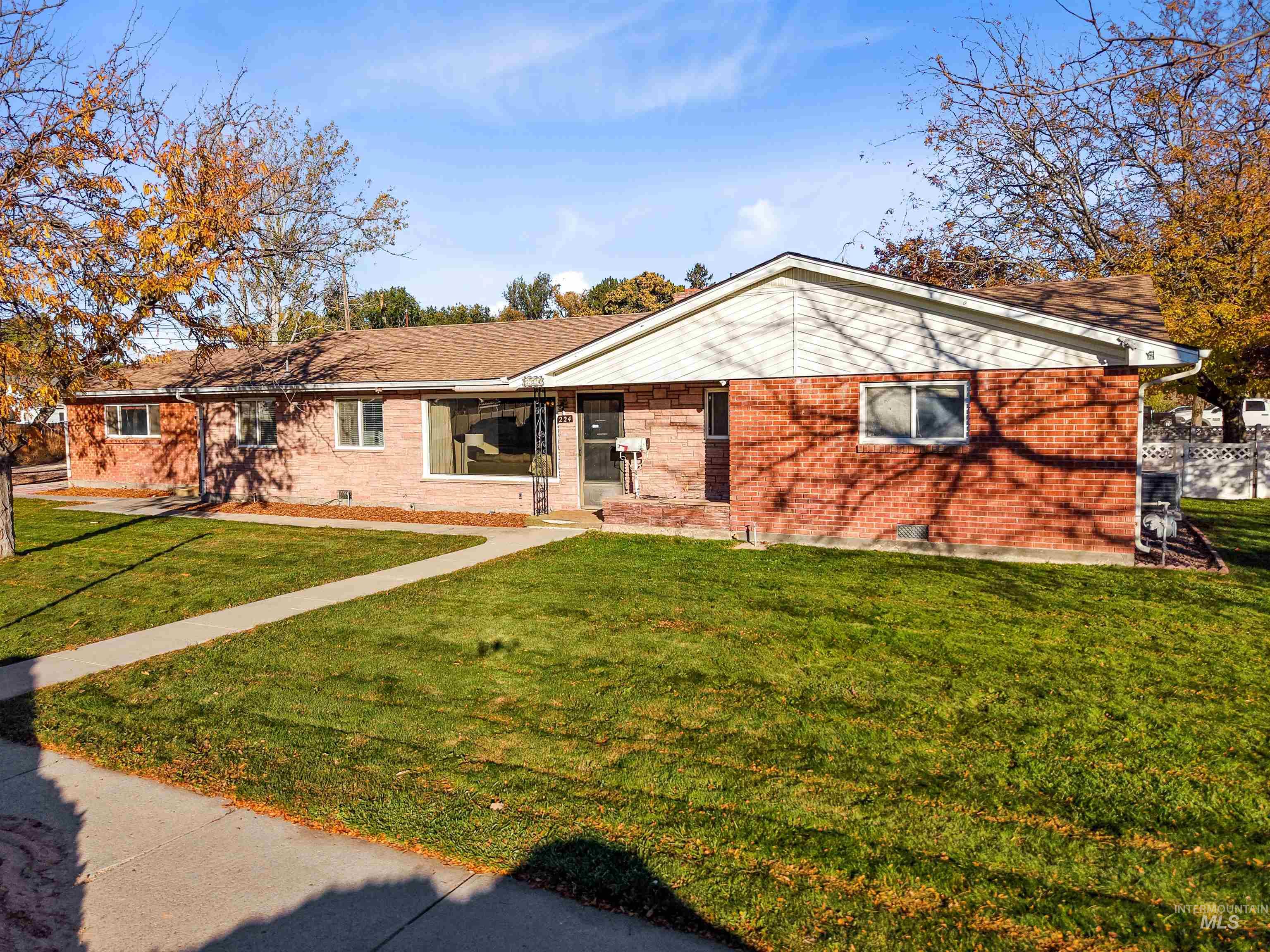 Ranch-style home featuring a front yard and brick siding