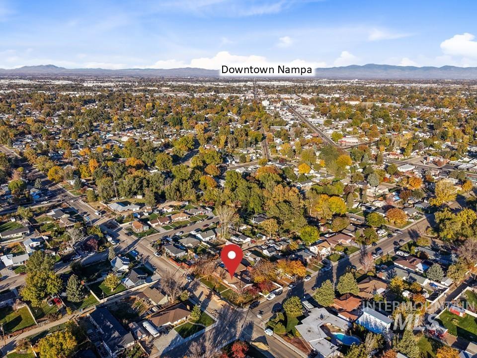 Aerial overview of property's location featuring mountains and nearby suburban area