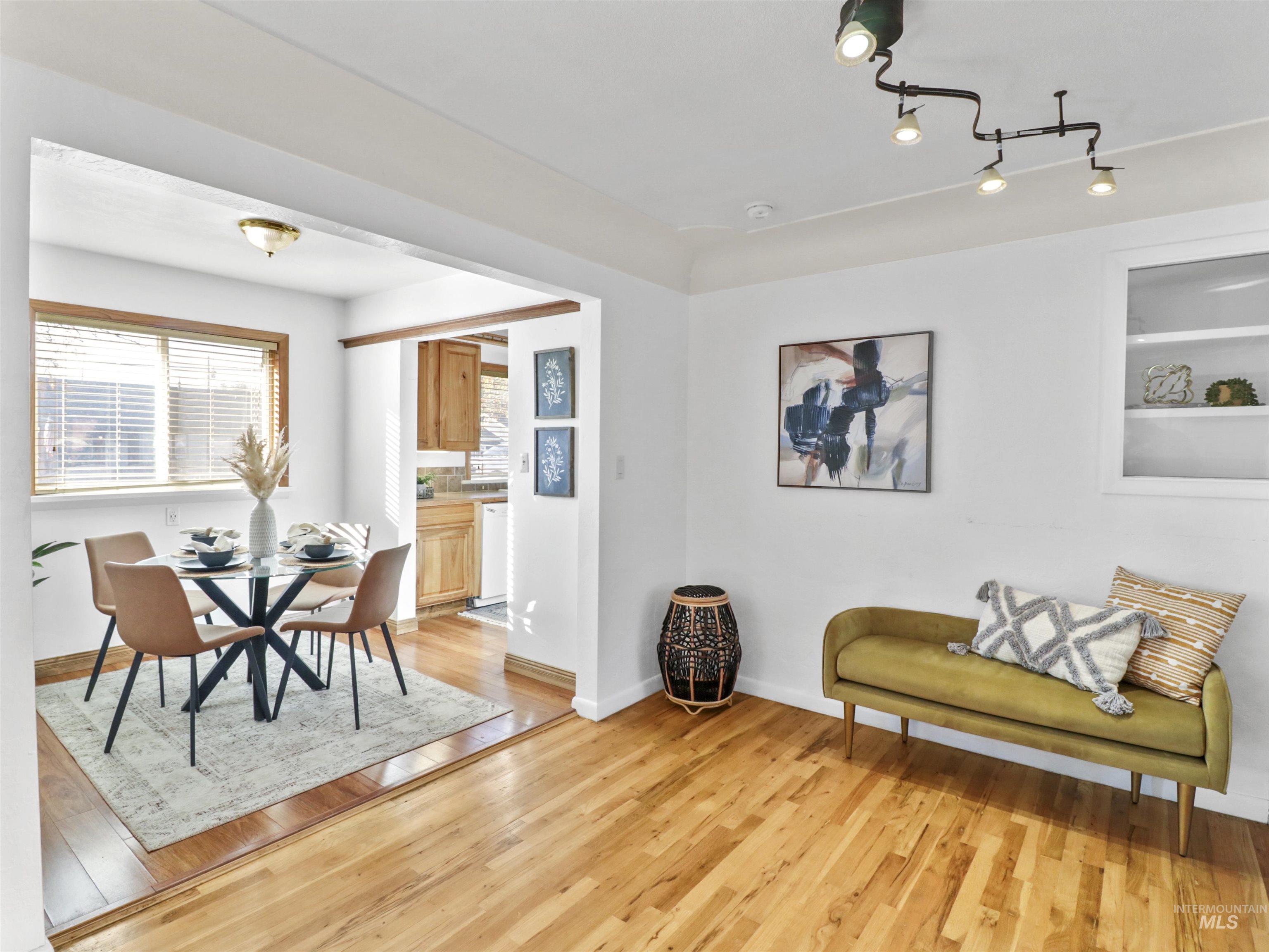 Dining area with light wood-style floors