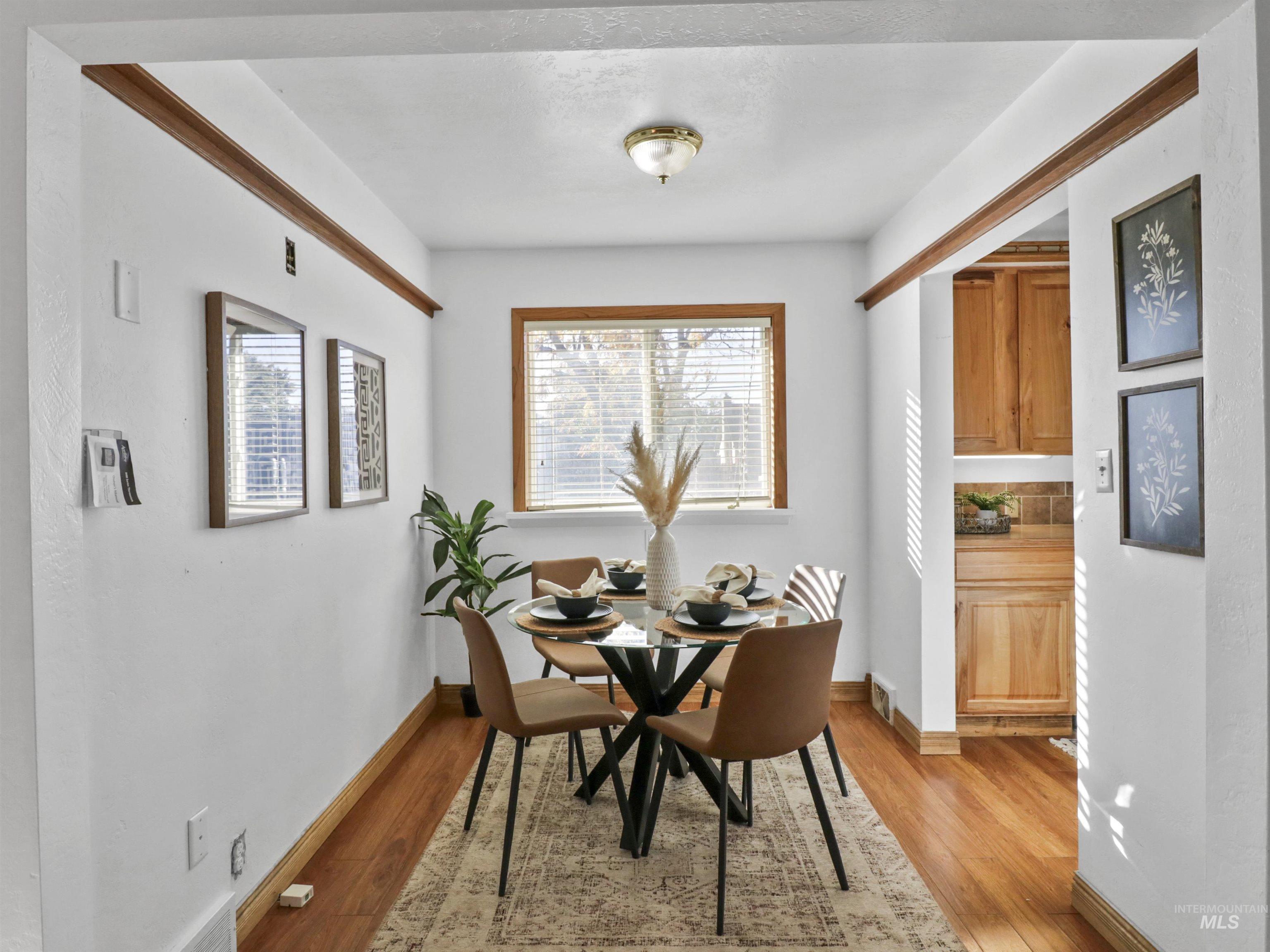 Dining room with light wood-style flooring and baseboards