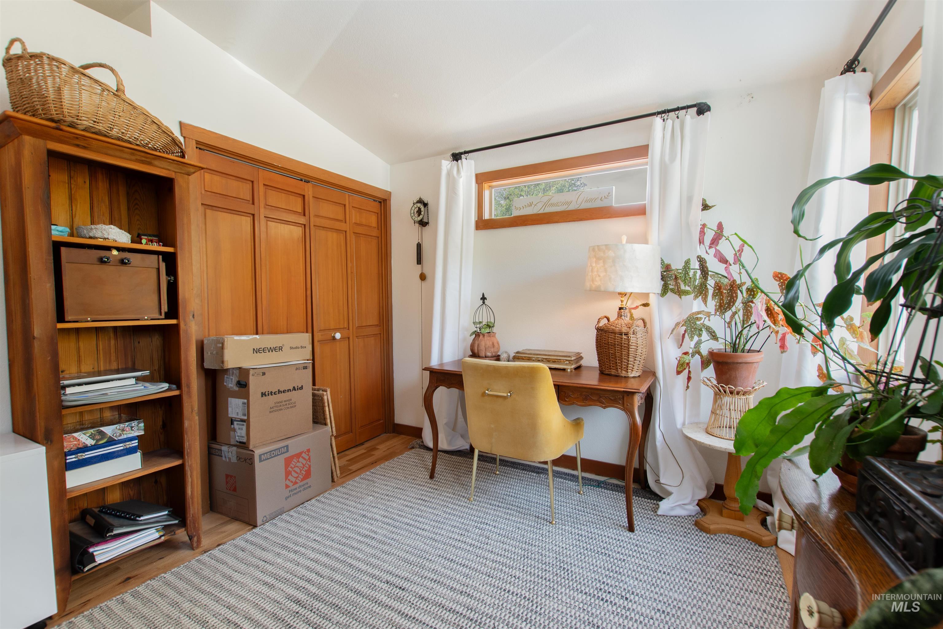 Office featuring lofted ceiling and light wood-type flooring