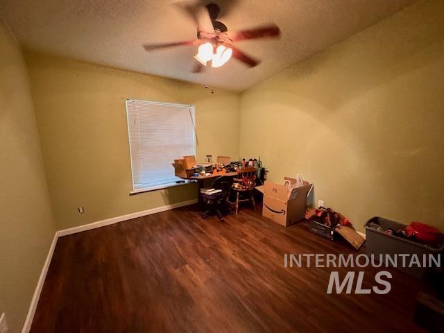 Office with dark wood-style flooring, a textured ceiling, and ceiling fan