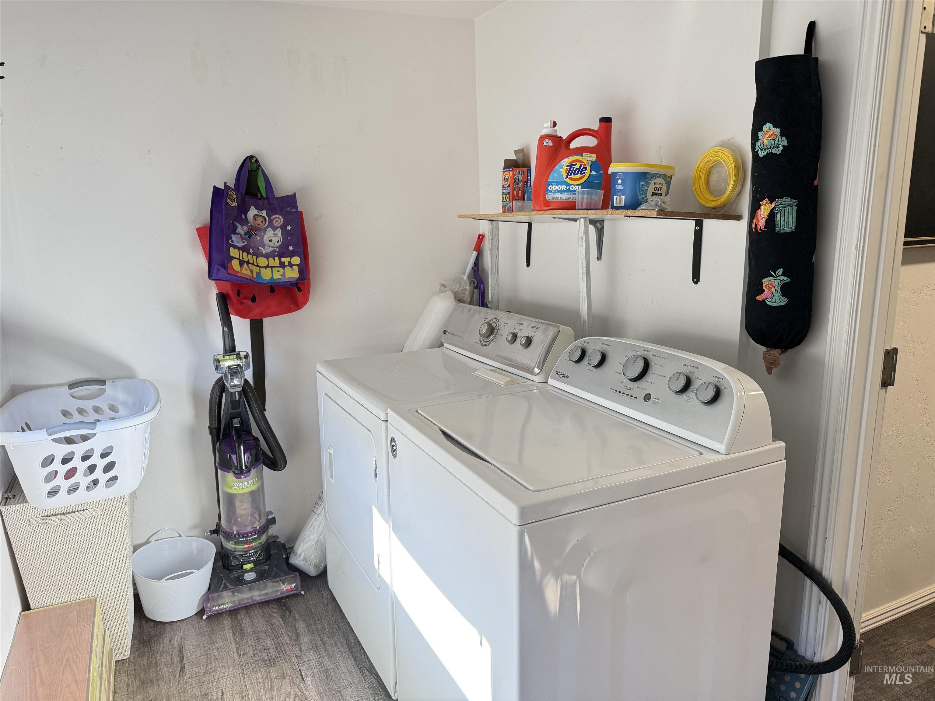 Washroom with washer and dryer and dark wood-style flooring