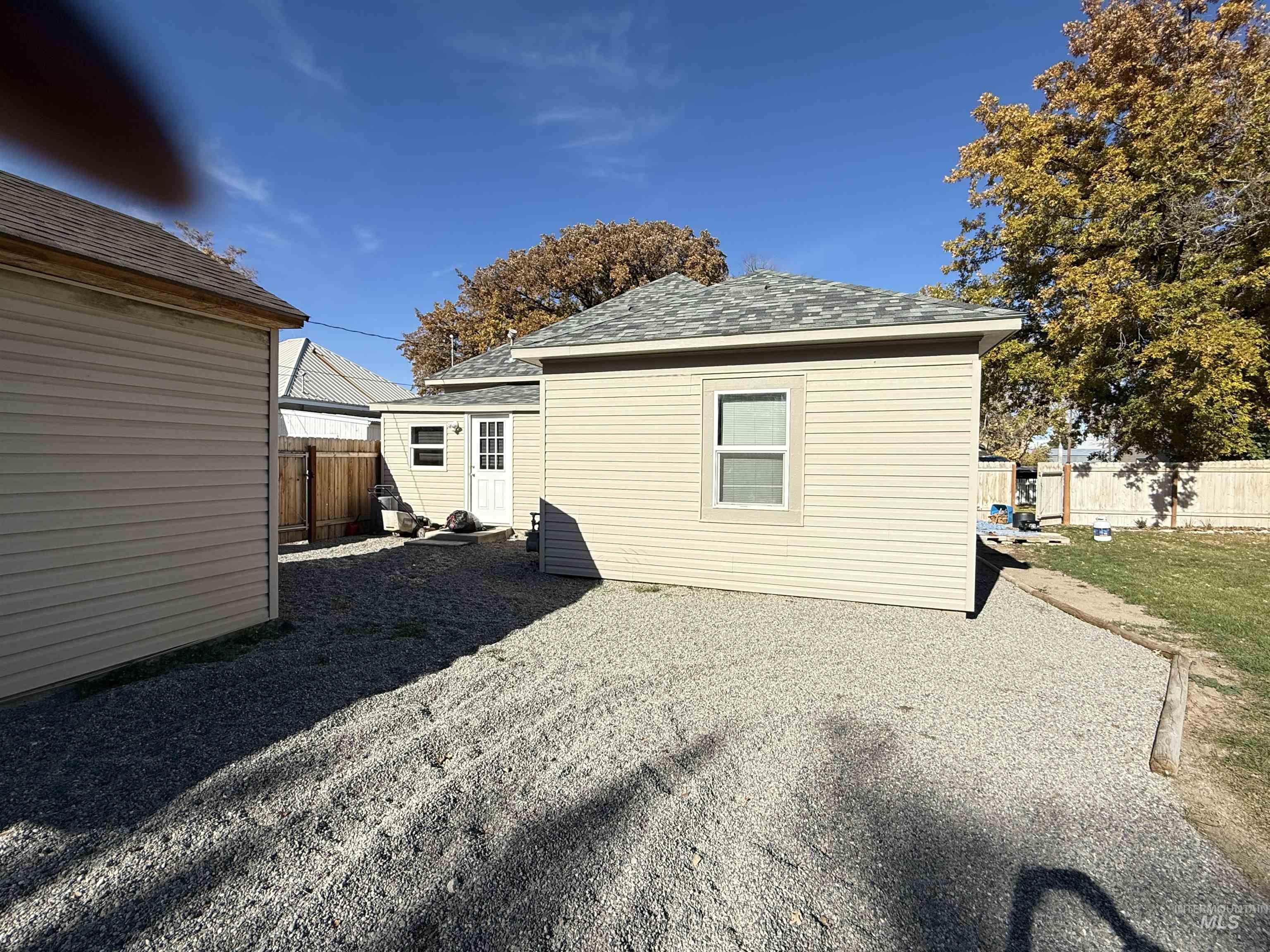 Rear view of property featuring a shingled roof