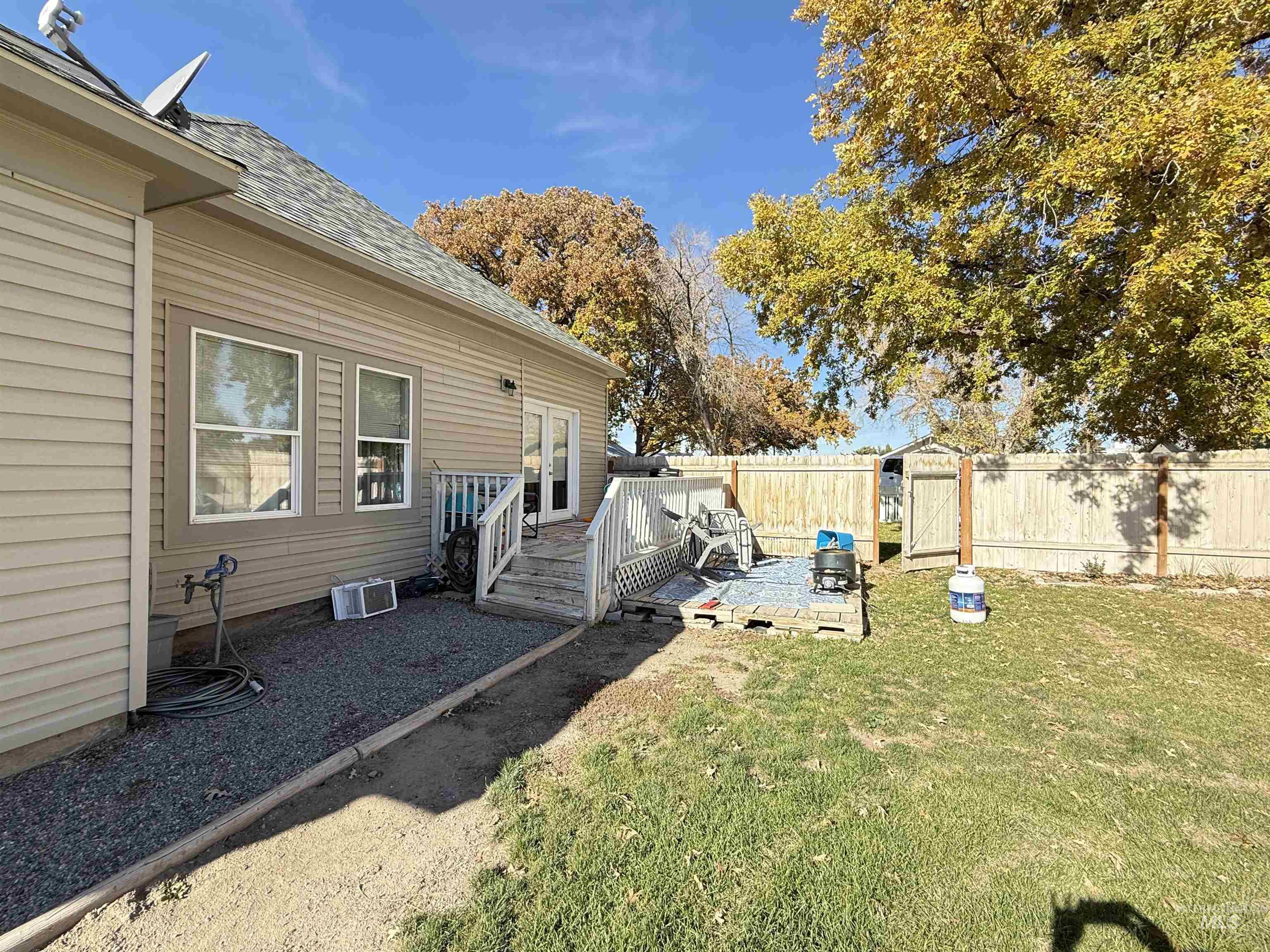 Fenced backyard with a wooden deck