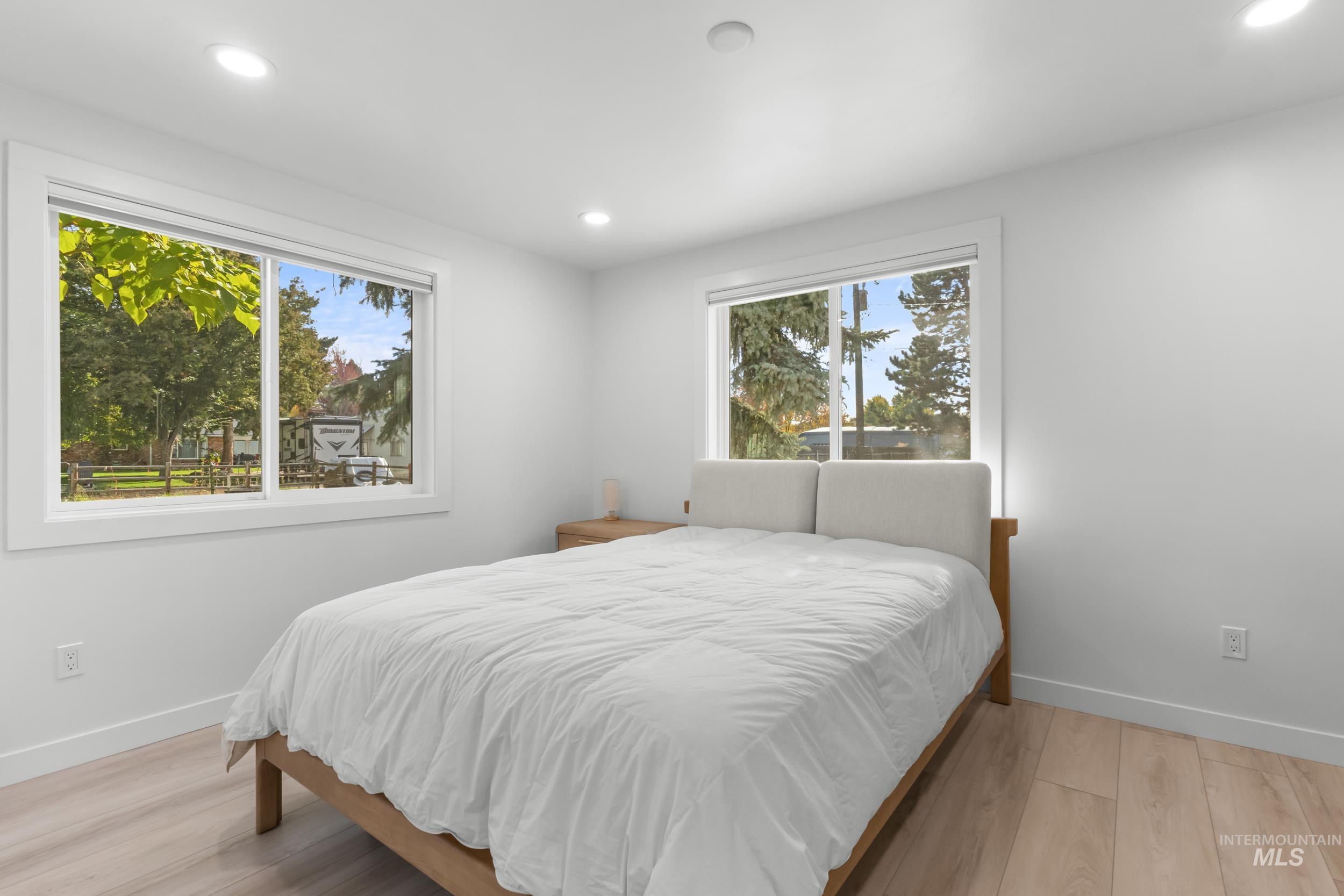 Bedroom with light wood-style flooring and recessed lighting