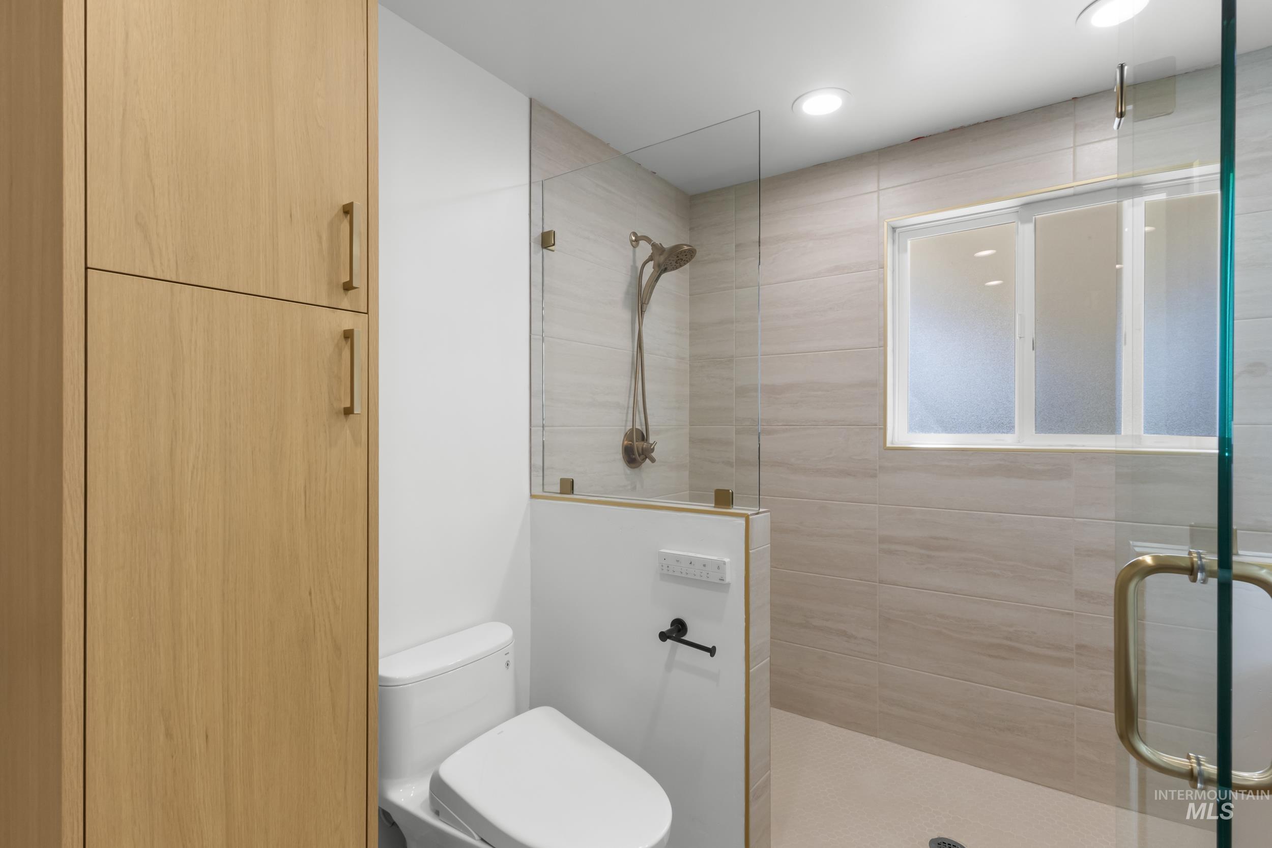 Full bath with a stall shower and recessed lighting
