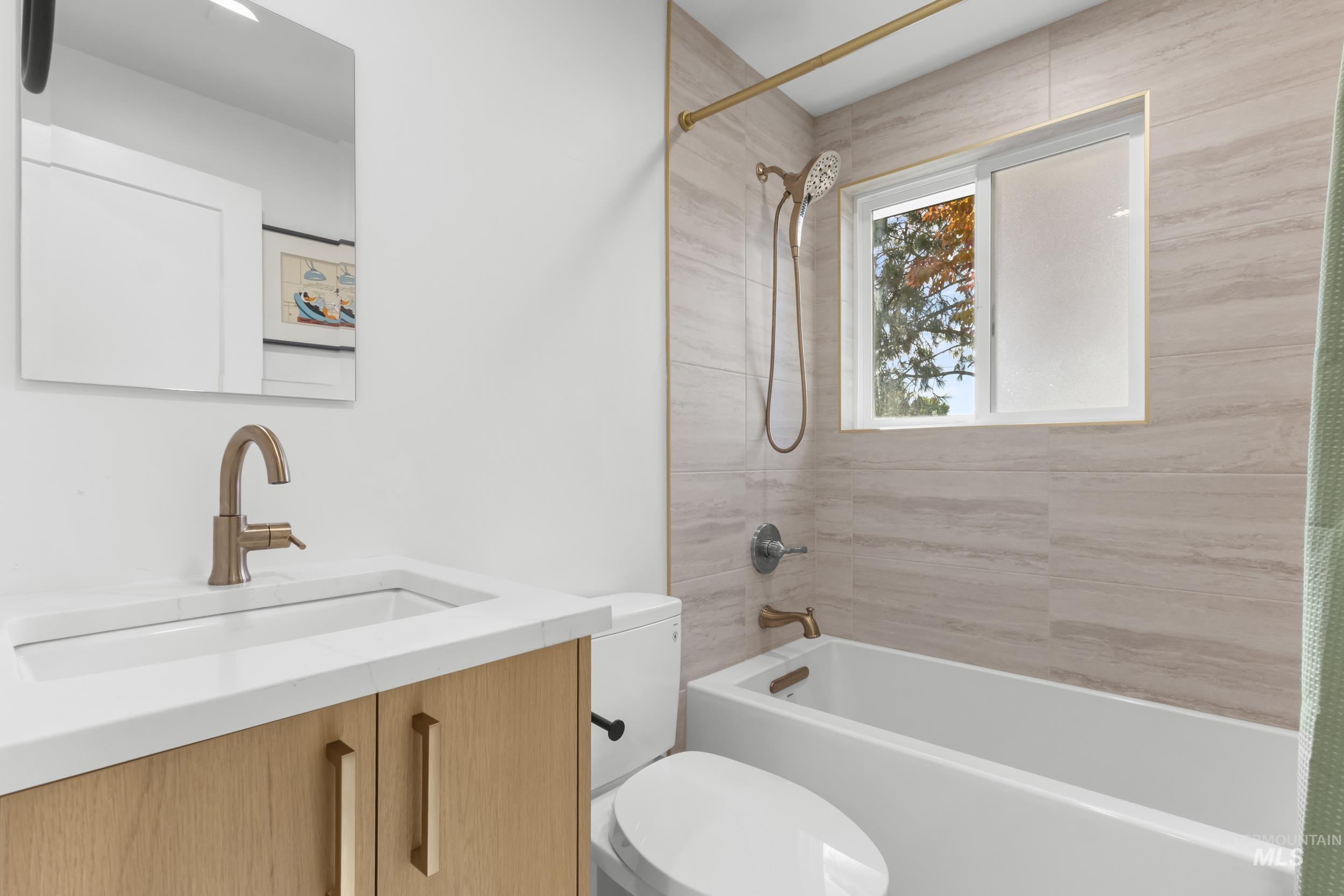 Bathroom with vanity and shower / bathtub combination with curtain