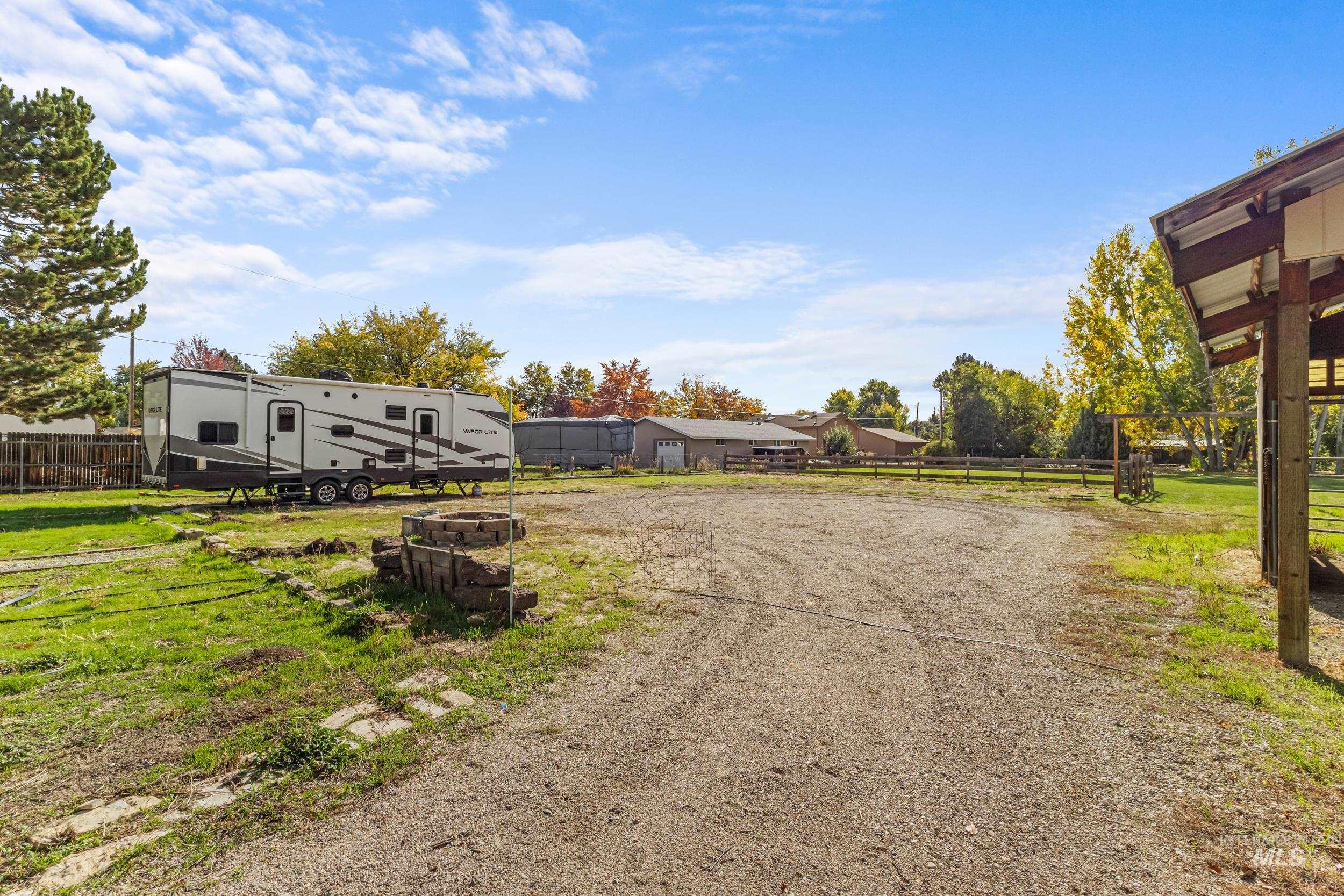 View of dirt / gravel road with a residential view