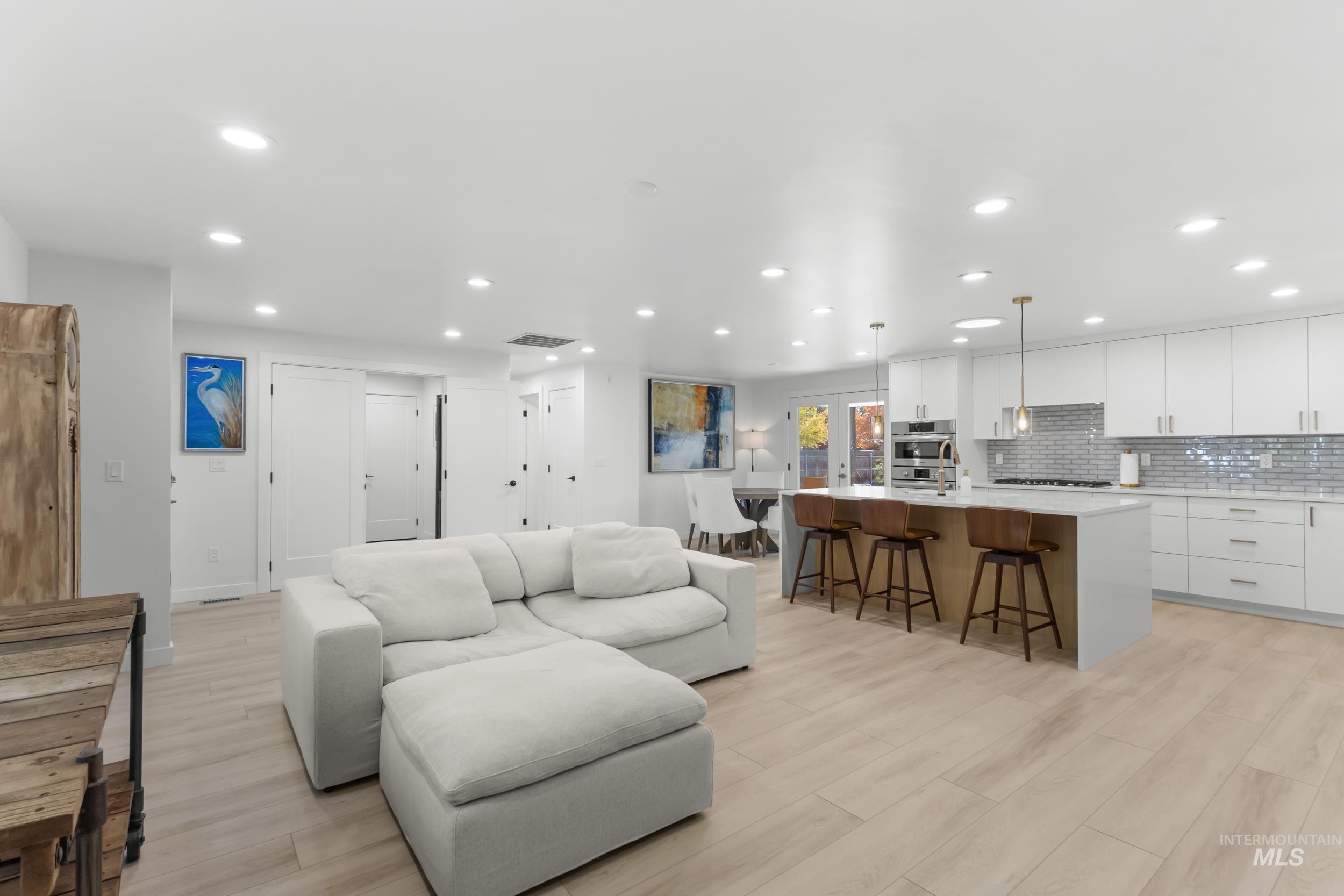 Living room featuring light wood-style flooring and recessed lighting