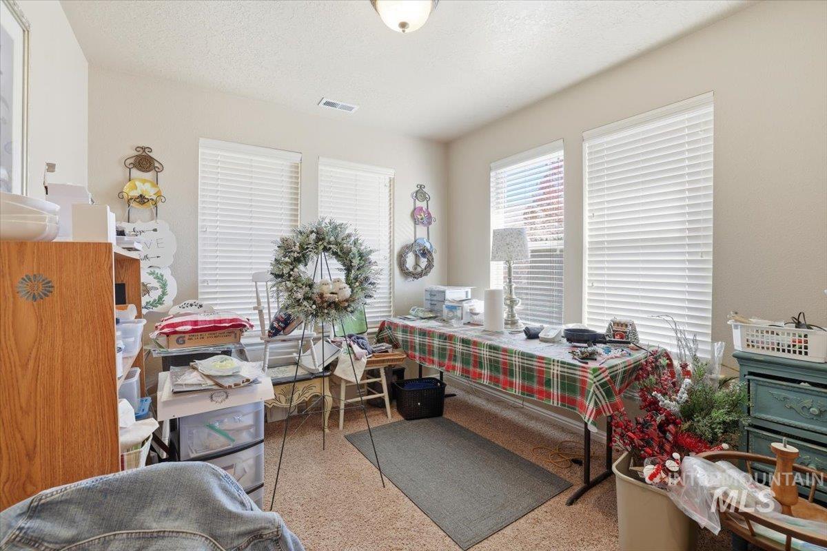 Home office with a textured ceiling and speckled floor