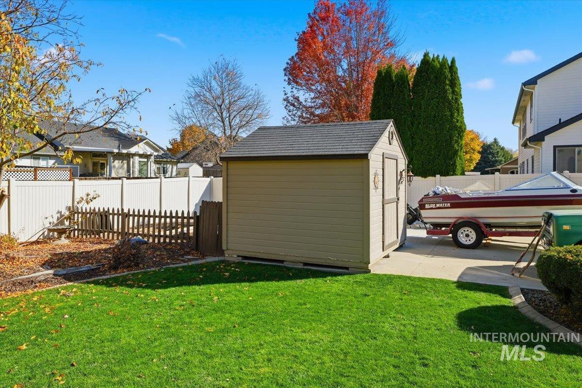 Fenced backyard with a storage unit
