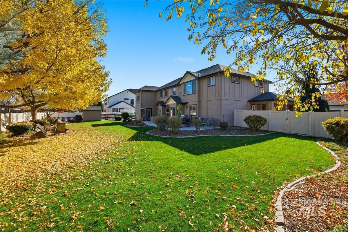 Back of house featuring a fenced backyard and board and batten siding