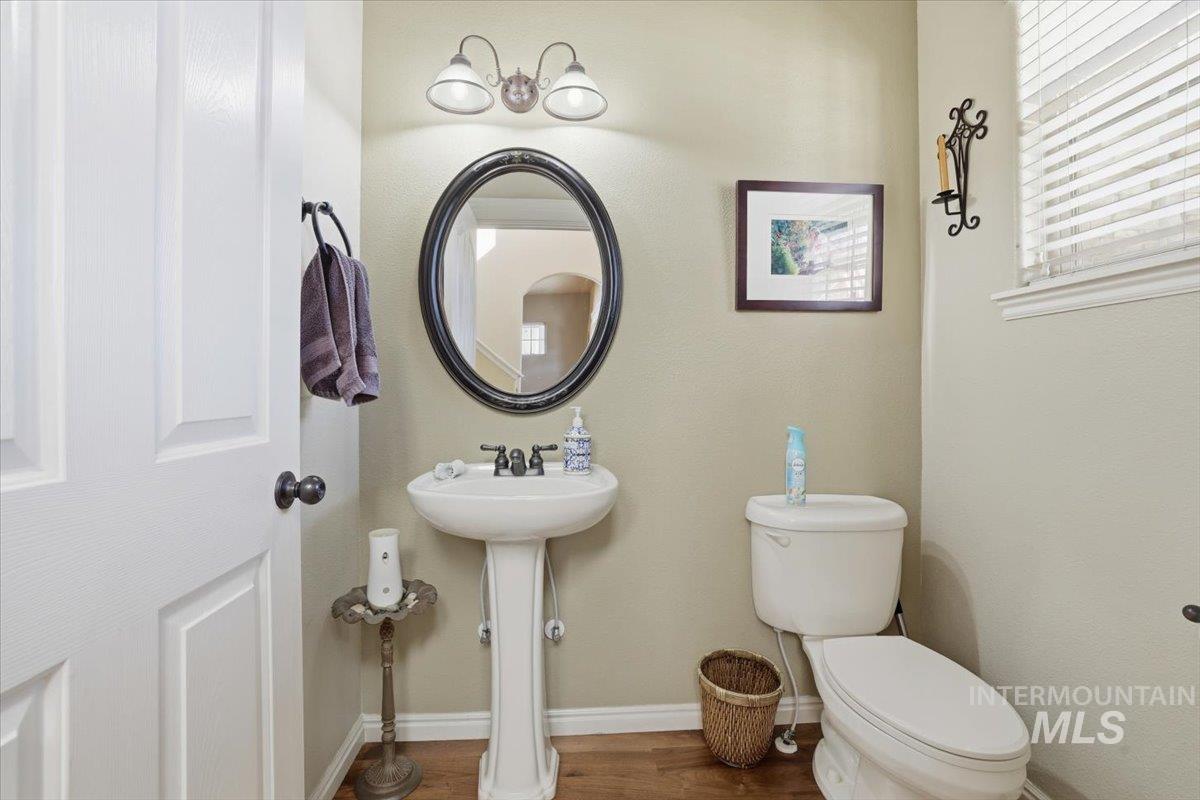 Bathroom with dark wood-style floors and baseboards